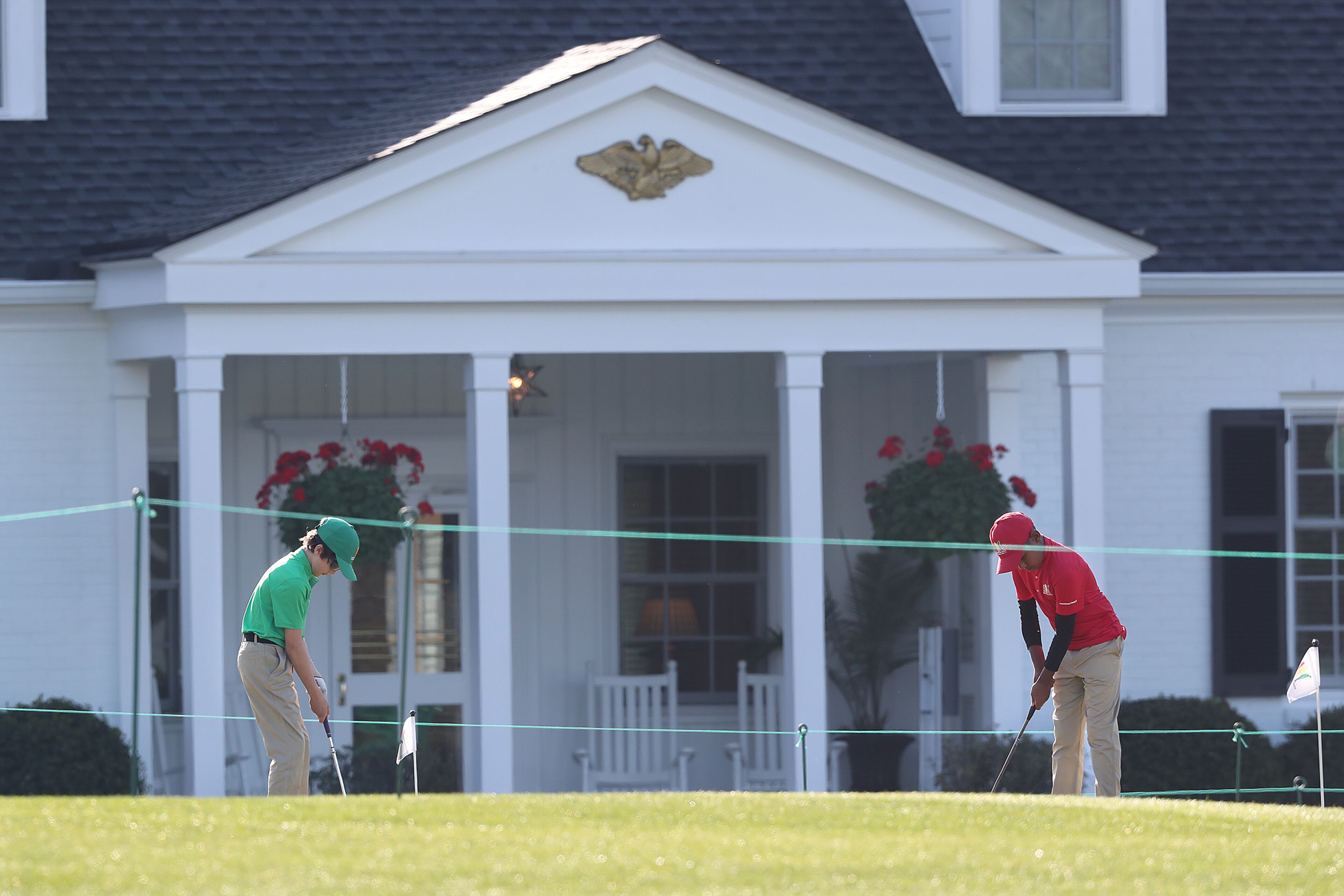 Youngsters practice their touch on the practice putting green in fron the the Eisenhower Cabin during the Drive, Chip, and Putt Championship at Augusta National Golf Club on Sunday, April 4, 2021, in Augusta. The Eisenhower Cabin was built in the early 1950s after Eisenhower's election as president. Because Ike was such a frequent visitor to Augusta National, he needed a secure place to stay. So this cabin — which, at the time, was sometimes called "the Little White House" — was built to specs provided by the Secret Service. Curtis Compton / Curtis.Compton@ajc.com