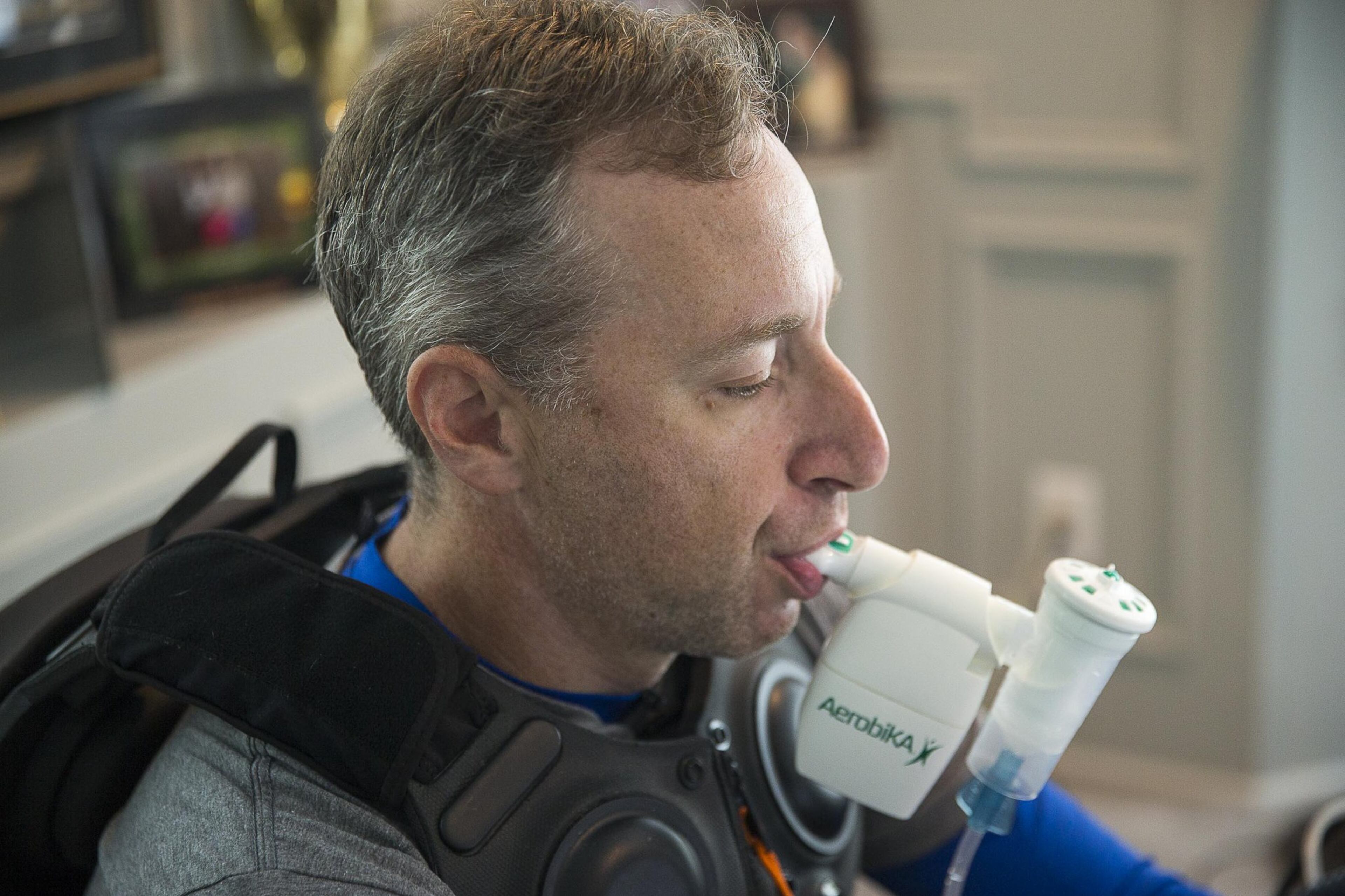 Andy Lipman takes his afternoon medication and undergoes therapy treatment at his home in Sandy Springs. This machine helps clear the mucus from his lungs. ALYSSA POINTER / ALYSSA.POINTER@AJC.COM