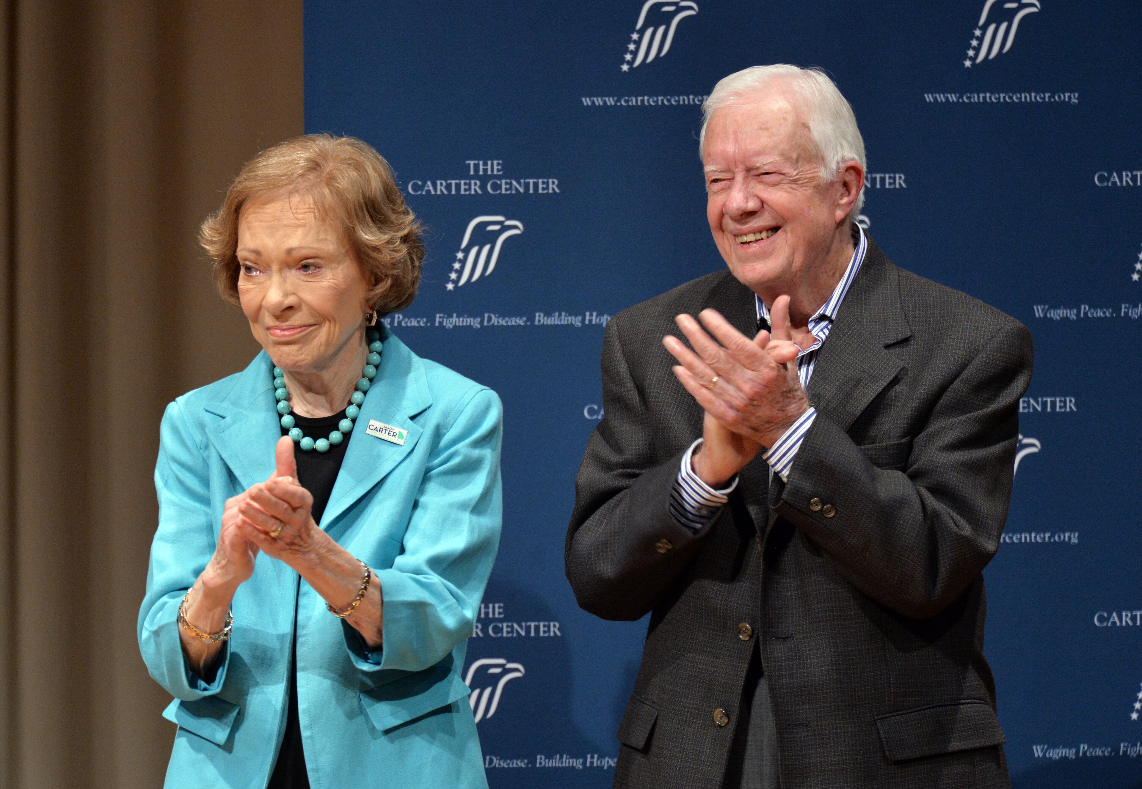 Former President Jimmy Carter celebrates with his wife Rosalynn as the former first lady gets emotional during an dedication ceremony and birthday celebration with staff and guests at the Day Chapel of the Ivan Allen III Pavilion at the Carter Center on Oct. 1, 2014. (Hyosub Shin / hshin@ajc.com)