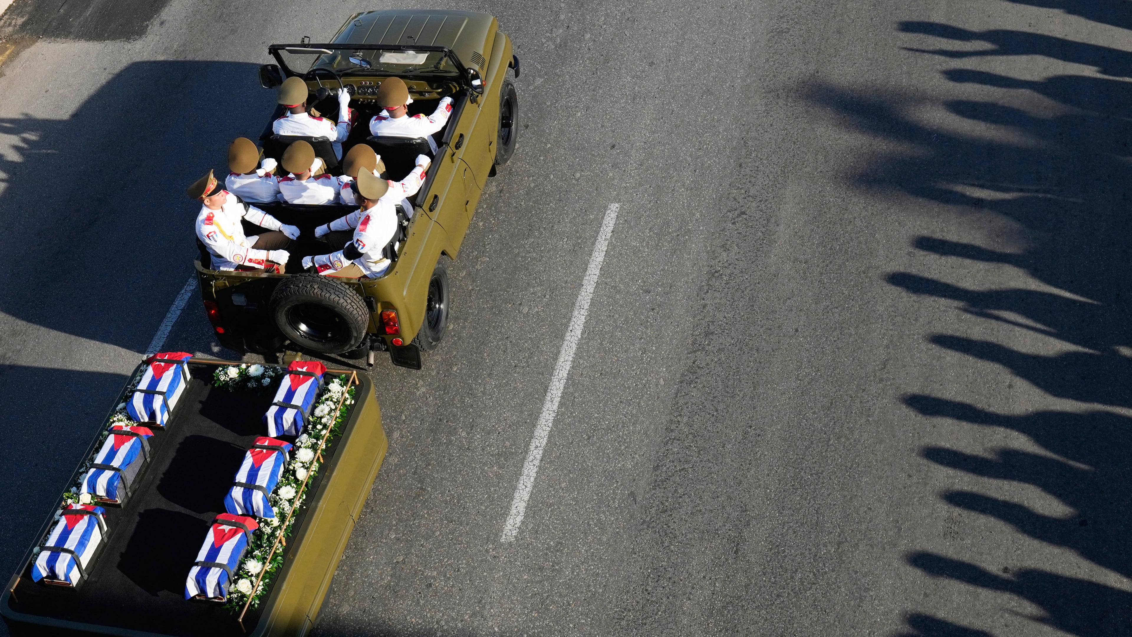 A motorcade transports urns containing the remains of Cuban officers, who were killed during the U.S. operation in Venezuela that captured Venezuelan President Nicolas Maduro, through Havana, Cuba, Thursday, Jan. 15, 2026. (AP Photo/Ramon Espinosa)