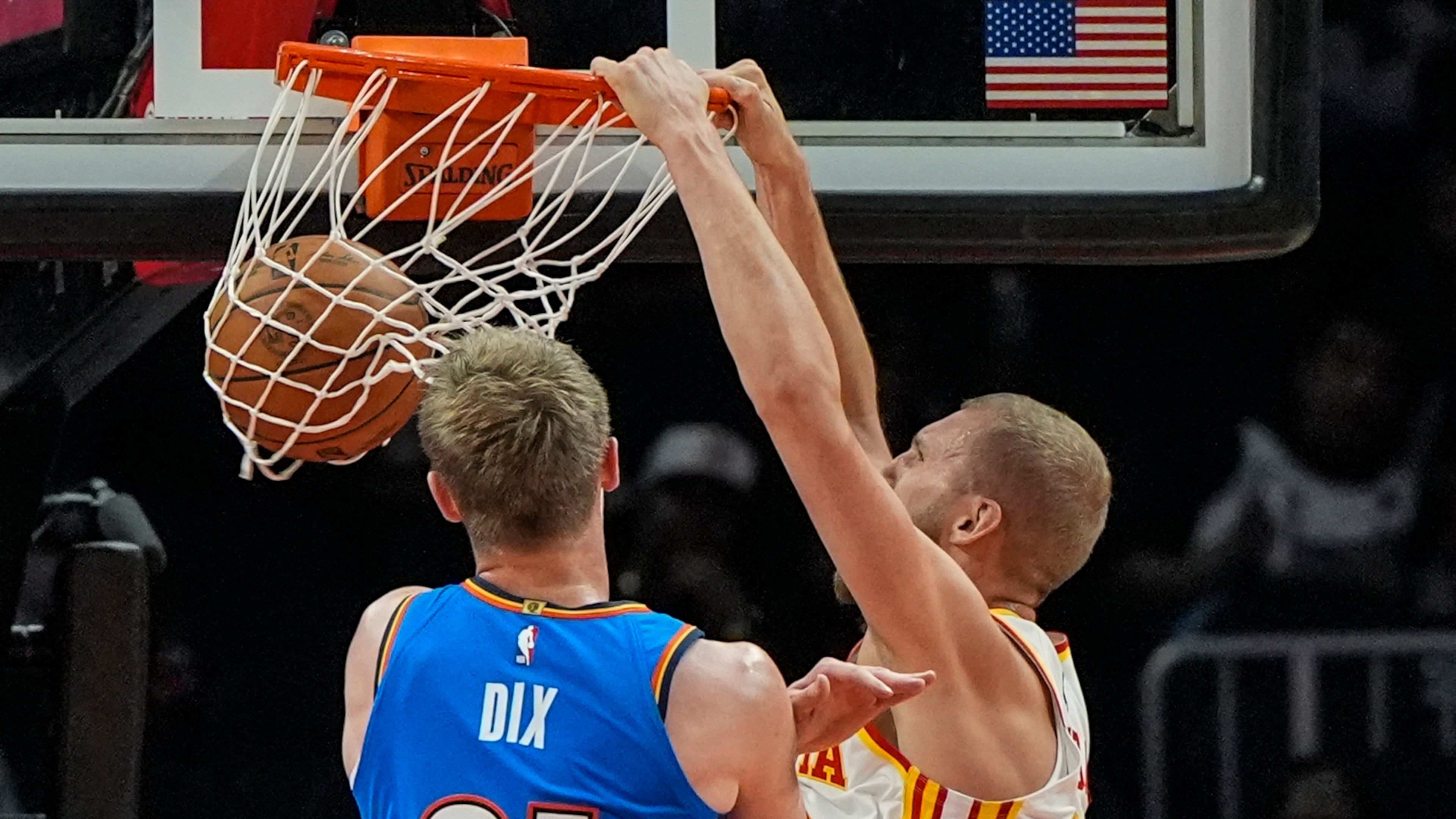 Atlanta Hawks center Jock Landale dunks over Oklahoma City Thunder guard Josh Dix (21) during the first half of an NBA basketball game, Monday, Oct. 12, 2026, in Atlanta. (Mike Stewart/AP)
