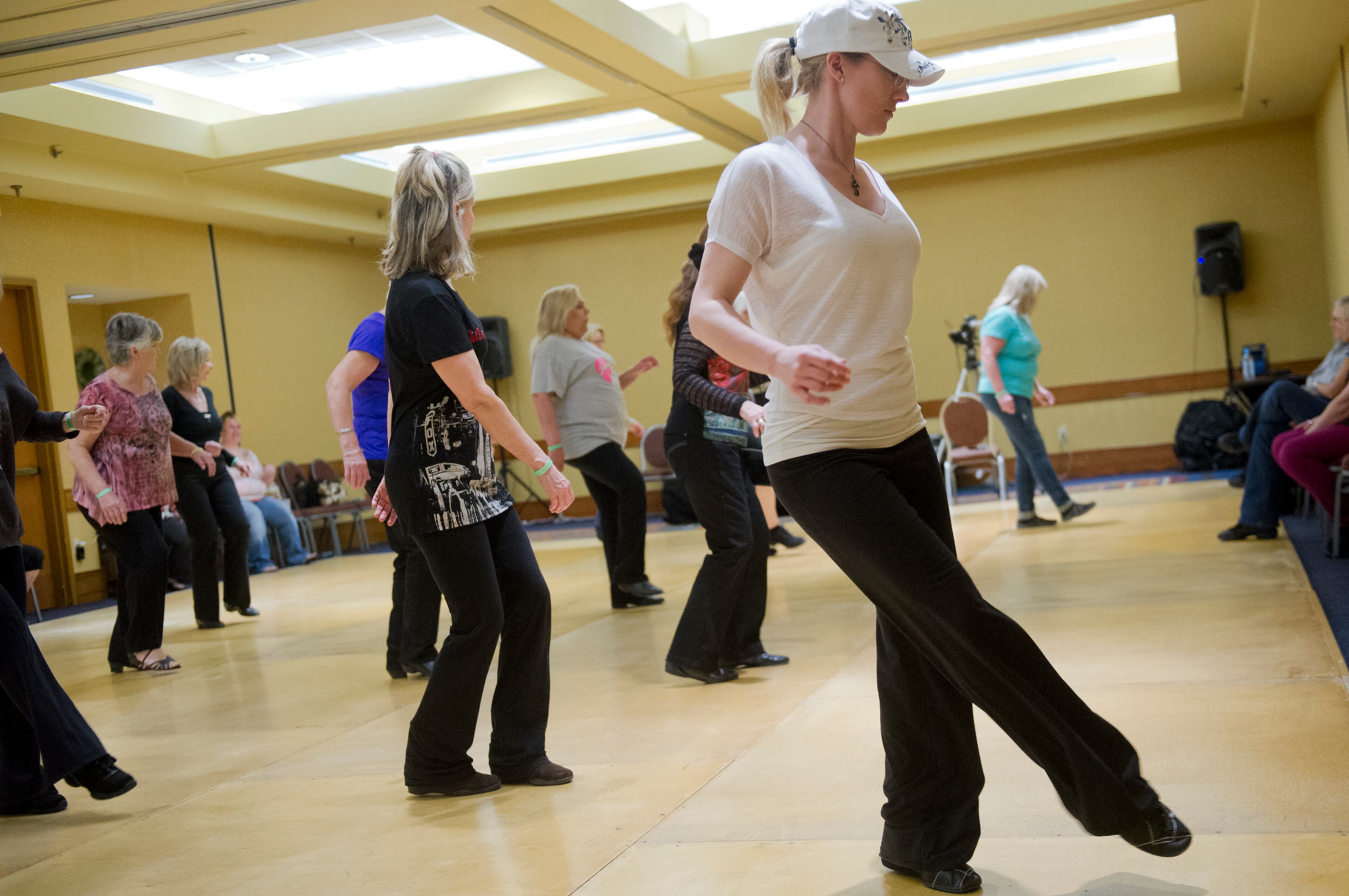 Kristi Davis (right) learns steps to the blurred lines during the Peach State Dance Festival at the Crown Plaza Ravinia hotel in Atlanta on Saturday, March 22, 2014. Approximately 1,000 country, swing and line dancers filled the hotel in Dunwoody for a weekend of instruction, competition, social dancing, and dance performances. The festival is in its 24th year and is the largest of its kind in the southeast.