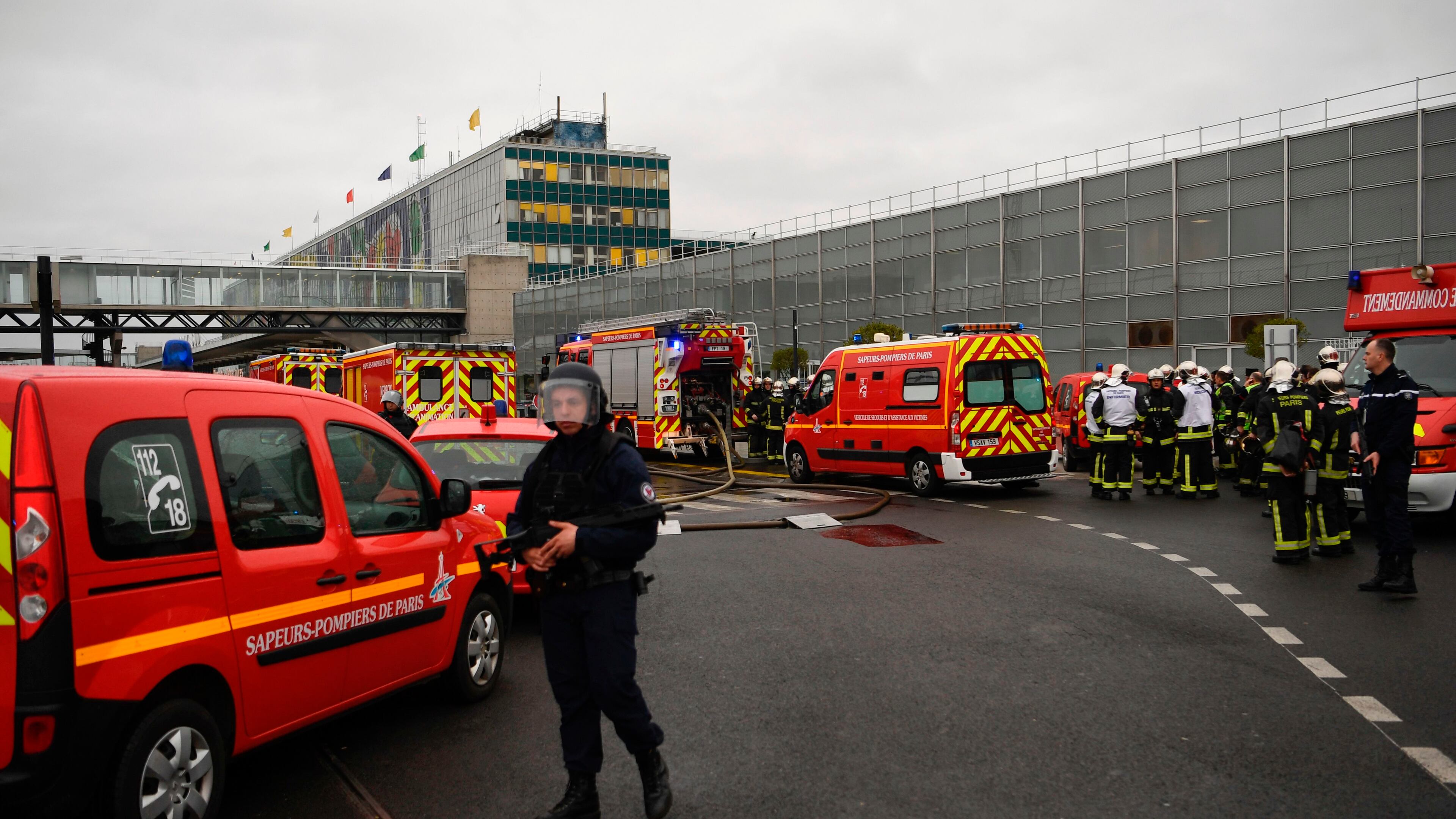 French policemen and firefighters secure the area at Paris' Orly airport on Saturday following the shooting of a man by French security forces.Security forces shot and killed a man who took a weapon from a soldier, the interior ministry said. Witnesses said the airport was evacuated following the shooting at around 8:30am. The man fled into a shop at the airport before he was shot dead, an interior ministry spokesman told AFP. The spokesman said no people were wounded in the incident.