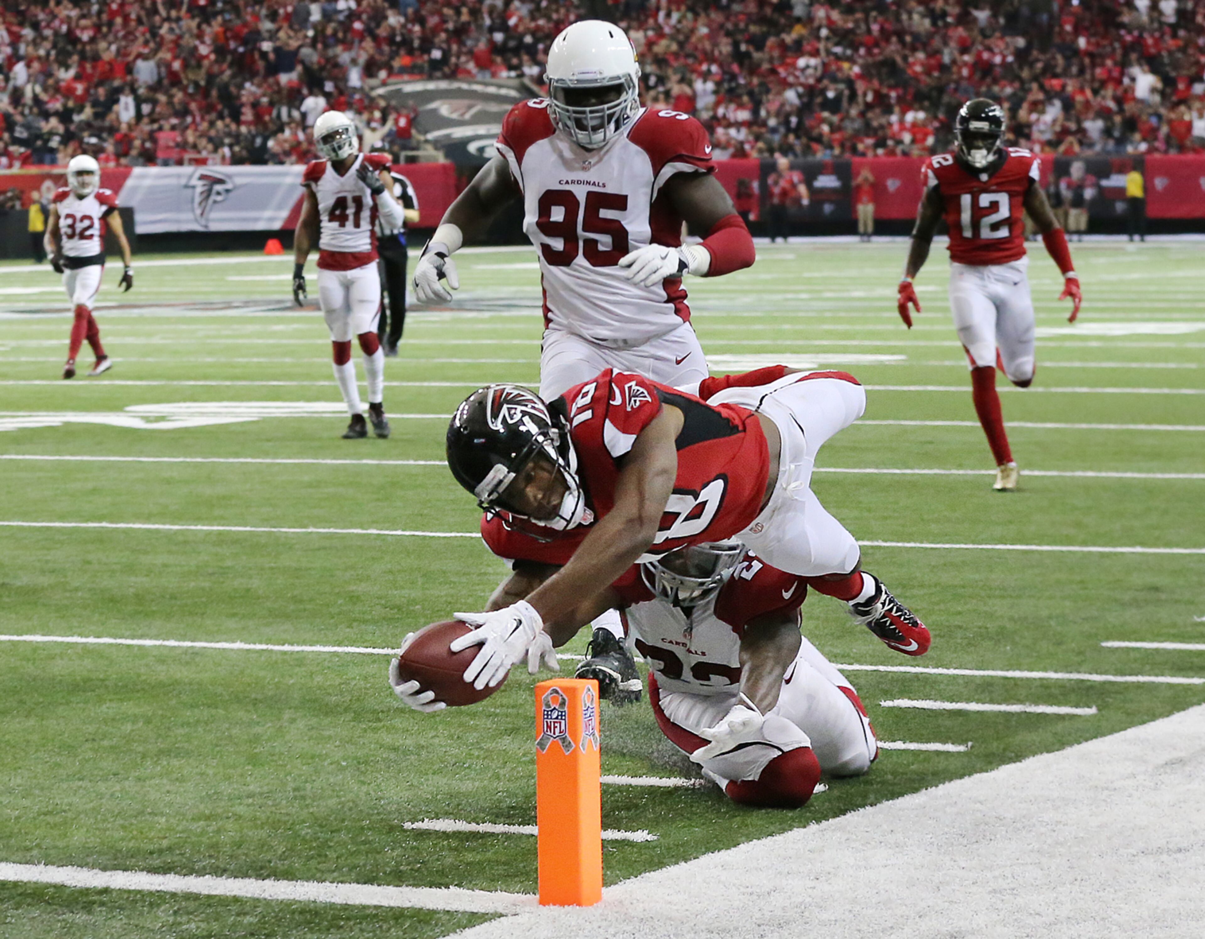 November 27, 2016, Atlanta: Falcons wide receiver Taylor Gabriel dives over Cardinals safety Tony Jefferson into the endzone for a touchdown and a 31-13 lead during the fourth quarter in an NFL football game on Sunday, Nov. 27, 2016, in Atlanta. The Falcons beat the Cardinals 38-19. Curtis Compton/ccompton@ajc.com