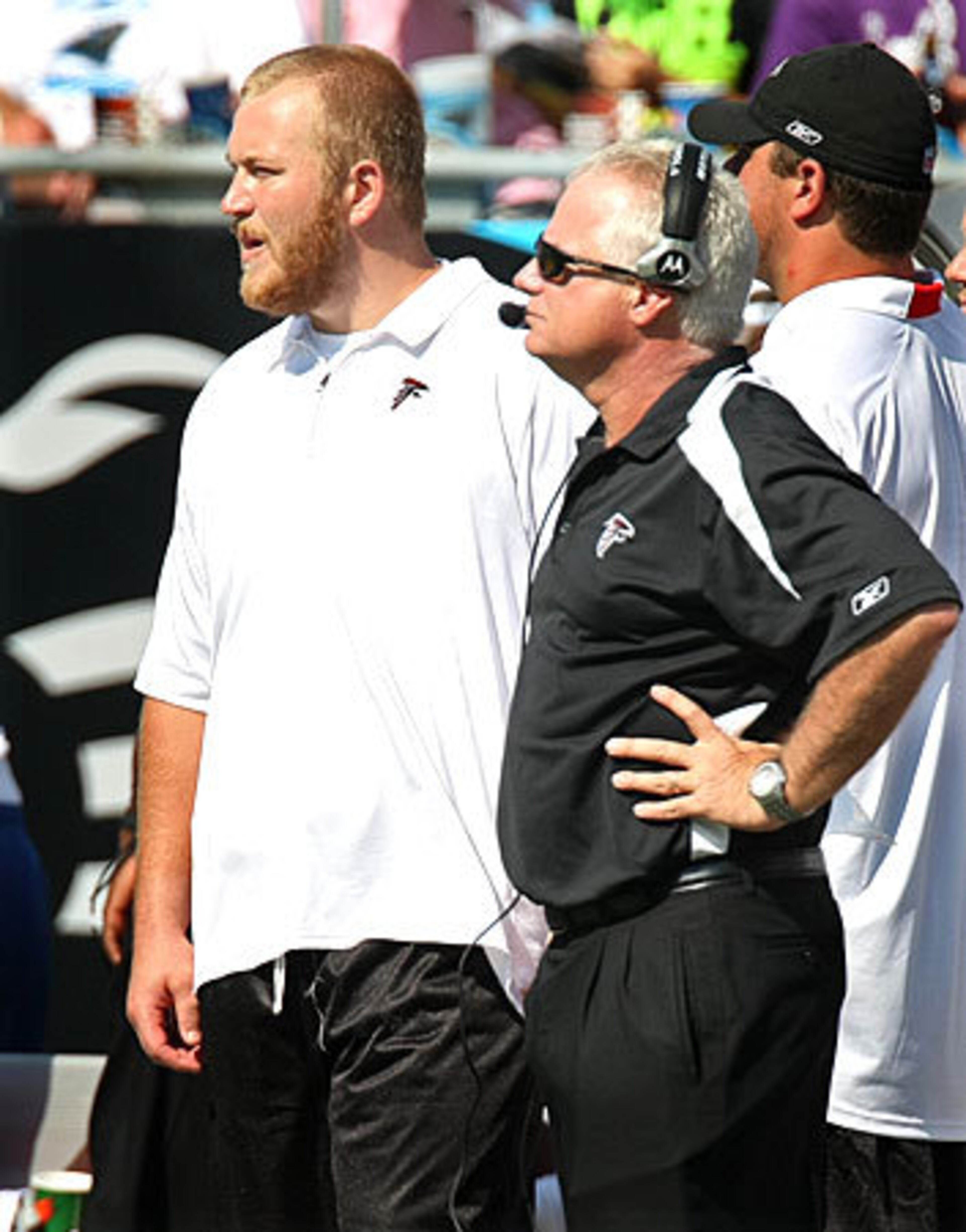 Falcons injured offensive lineman Sam Baker watches the game with coach Mike Smith.