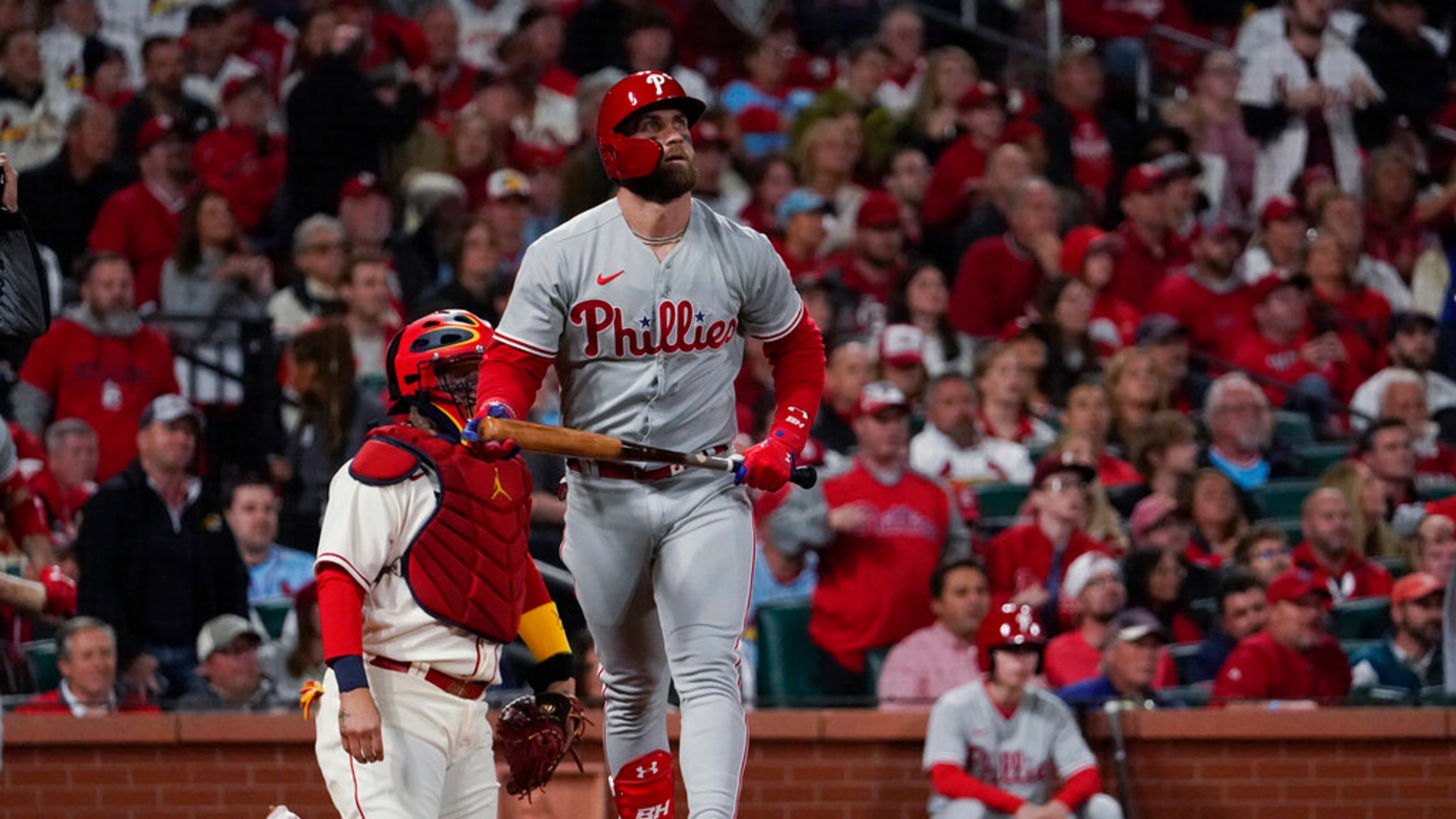 Philadelphia Phillies' Bryce Harper watches his solo home run against the St. Louis Cardinals during the second inning in Game 2 of an NL wild-card baseball playoff series Saturday, Oct. 8, 2022, in St. Louis. (AP Photo/Jeff Roberson)