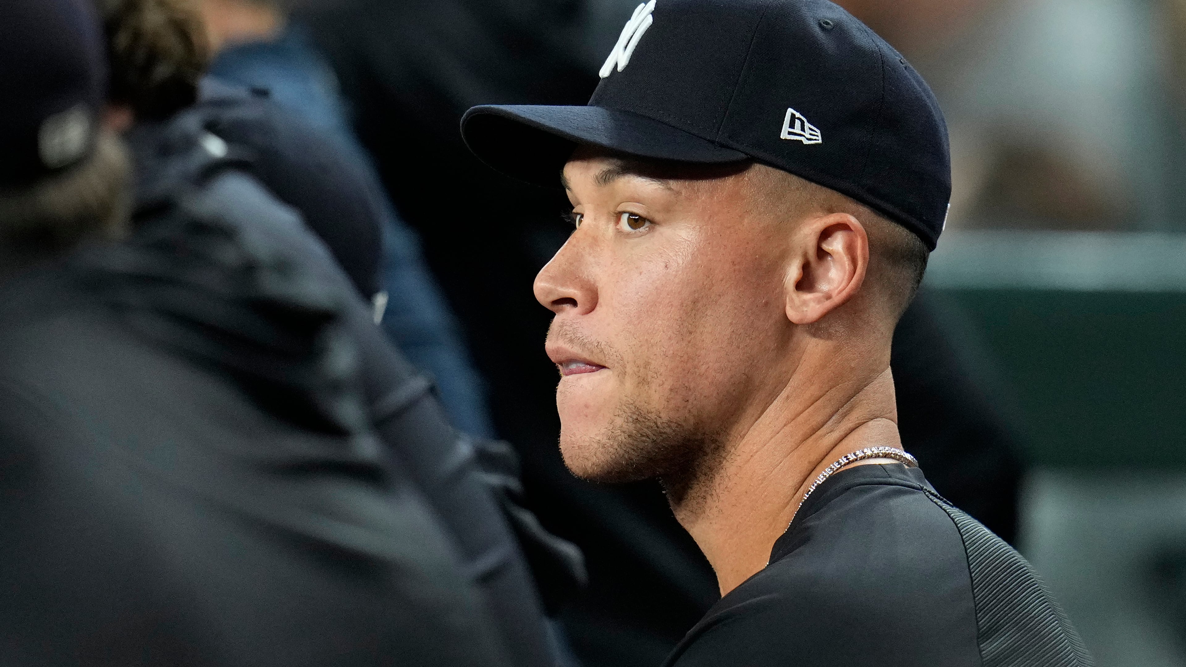 Injured New York Yankees' Aaron Judge sits with teammates in the dugout during the sixth inning of a baseball game against the Arizona Diamondbacks, Friday, Sept. 18, 2026, in Phoenix. (AP Photo/Ross D. Franklin)