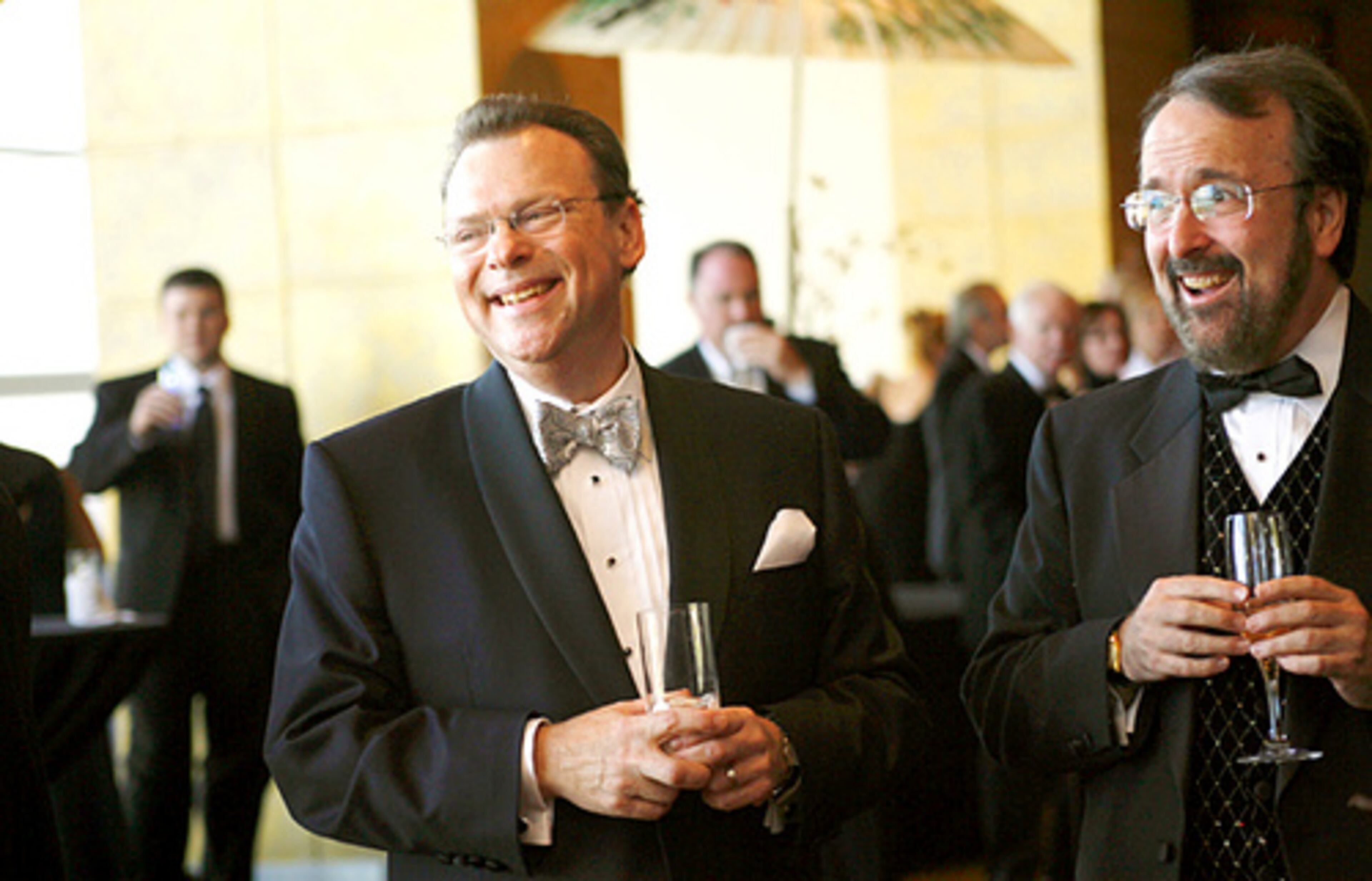 Dennis Hanthorn, Zurich general director, enjoy the champagne reception with Thomas Guffin (right) of Marietta.