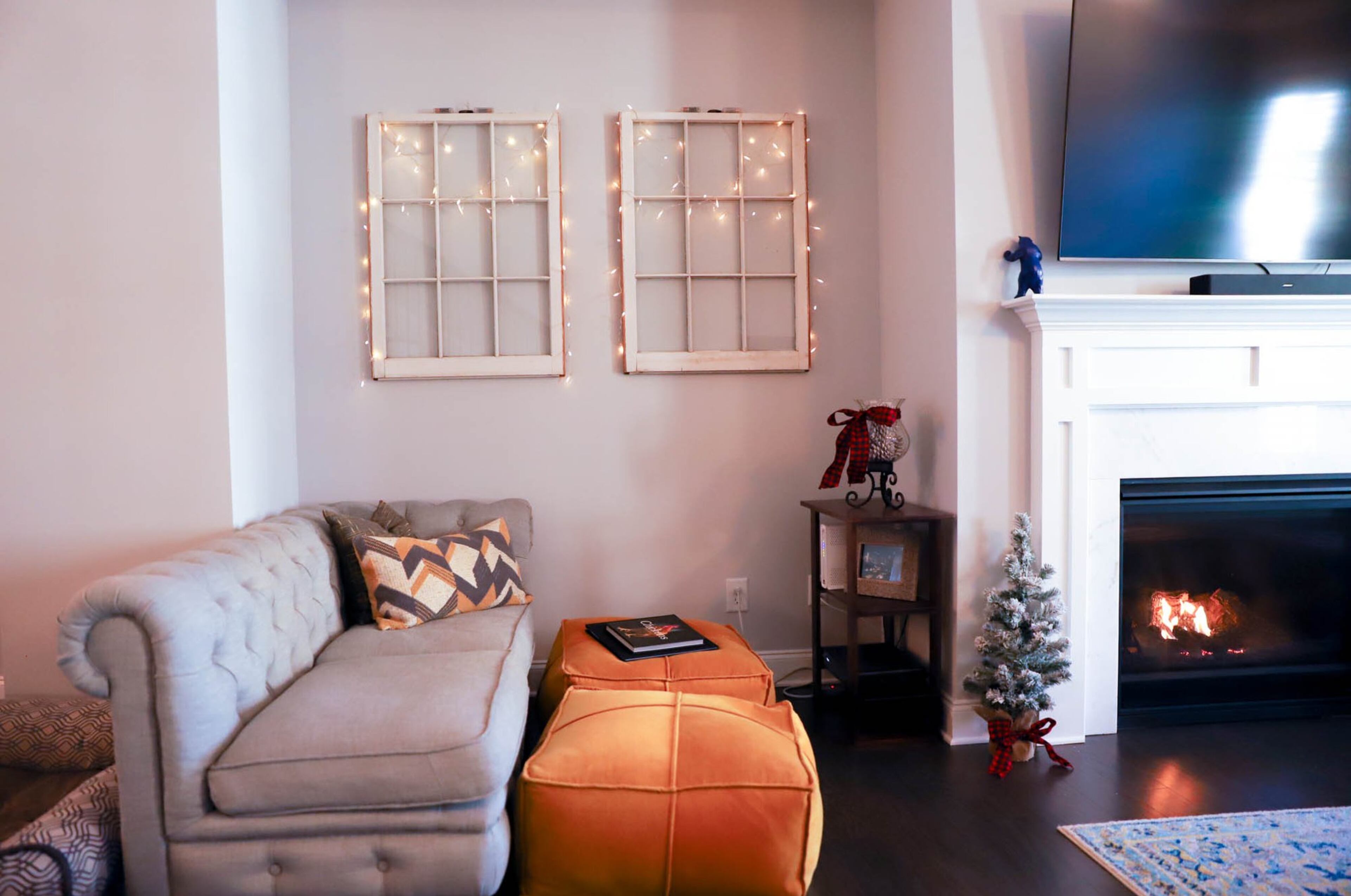 Windows from Zach Sabo’s childhood Woodstock home have been repurposed into a whimsical display that twinkles with white lights all year long. Complete with a light gray chaise lounge from RH and golden poufs from Intaglia Home Collection, the seating area was designed to be a cozy reading nook. Text by Annie Campbell/Fast Copy News Service. Photo by Reynolds Rogers/Fast Copy News Service.