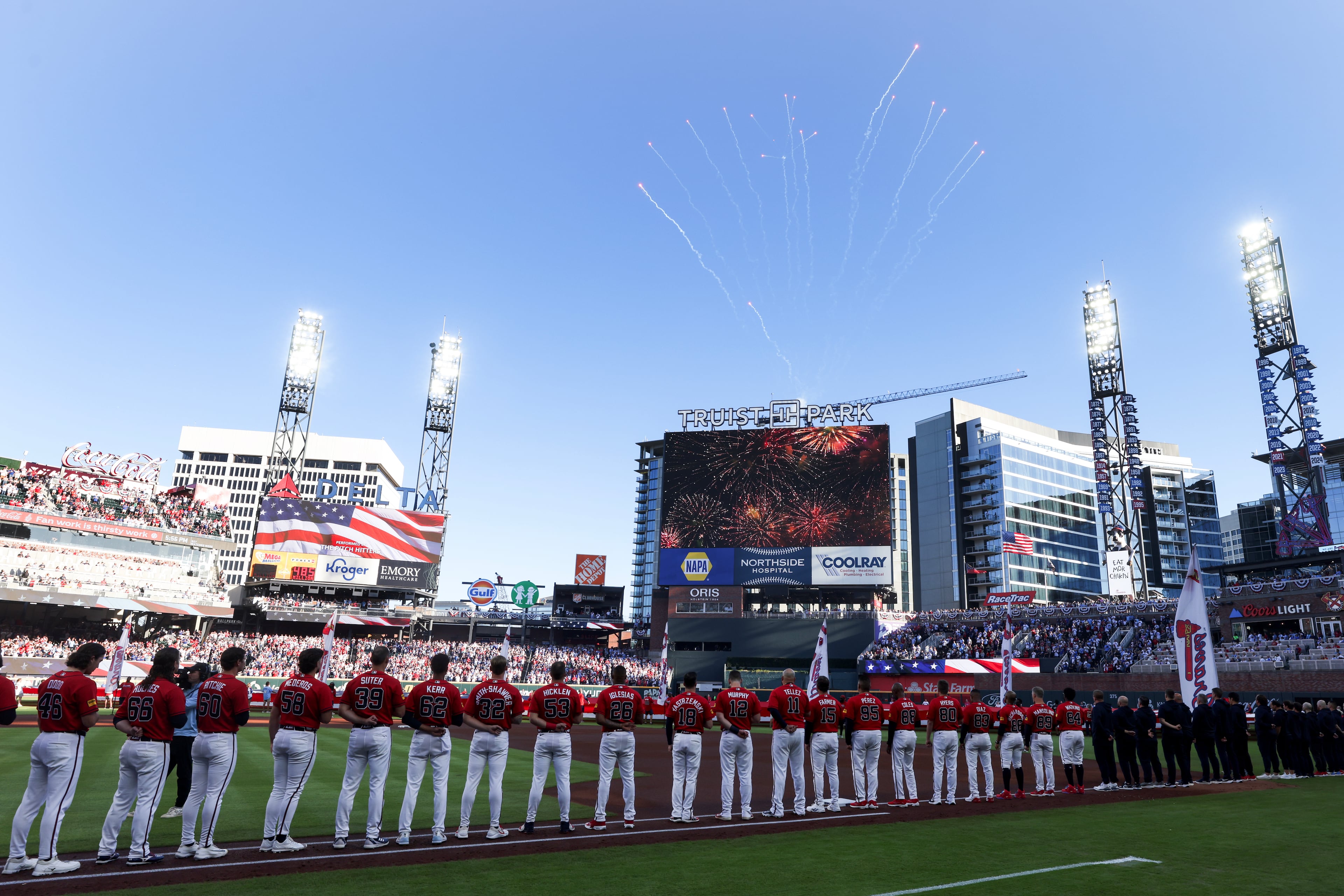 The Atlanta Braves watch fireworks during the U.S. national anthem before Game 3 of the MLB National League Division Series between the Atlanta Braves and the Los Angeles Dodgers, Tuesday, Oct. 6, 2026, in Atlanta. (Jason Getz/AJC)