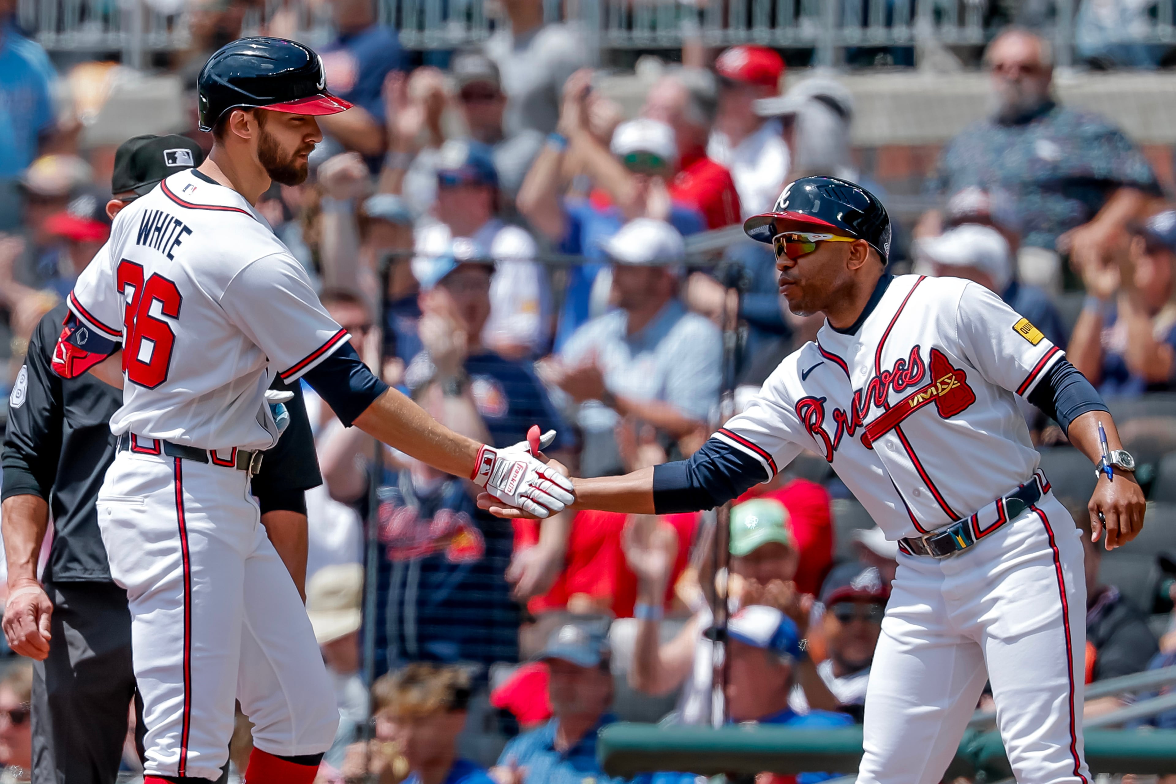 Braves outfielder Eli White (left) is congratulated by first base coach Antoan Richardson after hitting an RBI single against the Tigers on Thursday, April 30, 2026, in Atlanta. (Erik S. Lesser/AP)