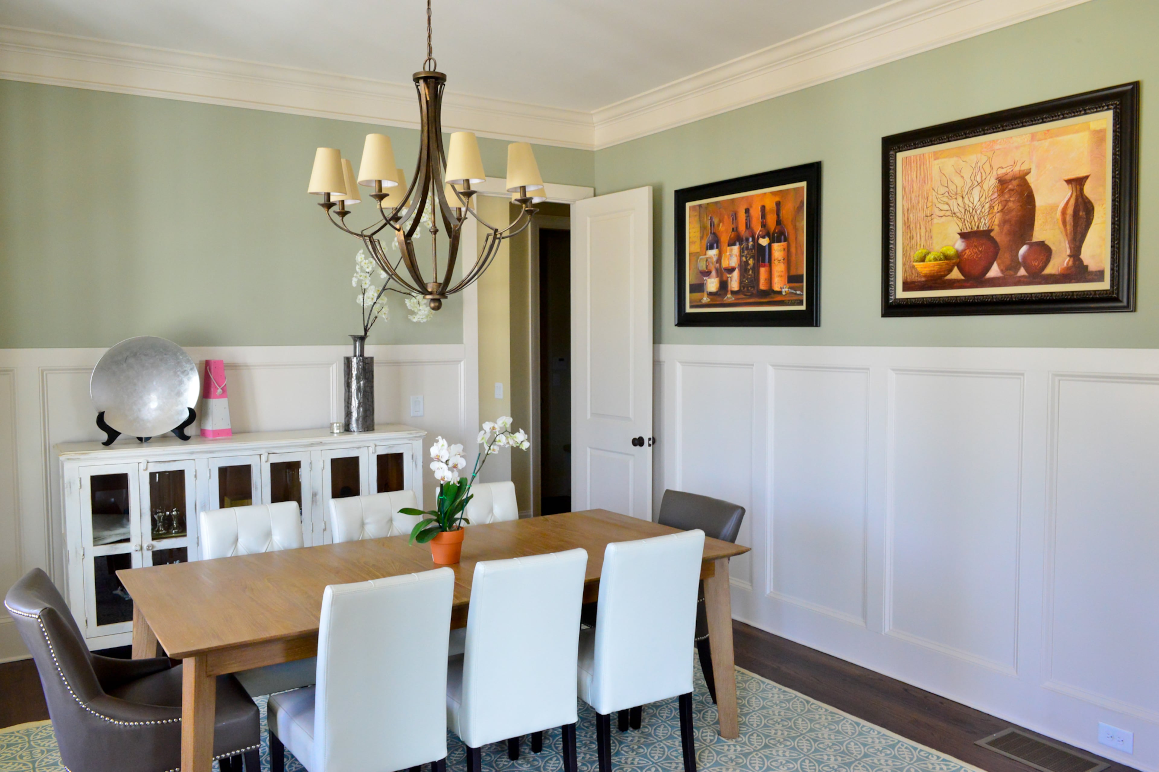 Justin and Sophia DeCouto's dining room features hardwood floors, paneling, a table from Crate and Barrel, leather chairs bought off eBay and a buffet from Southern Comforts Consignments in Alpharetta.