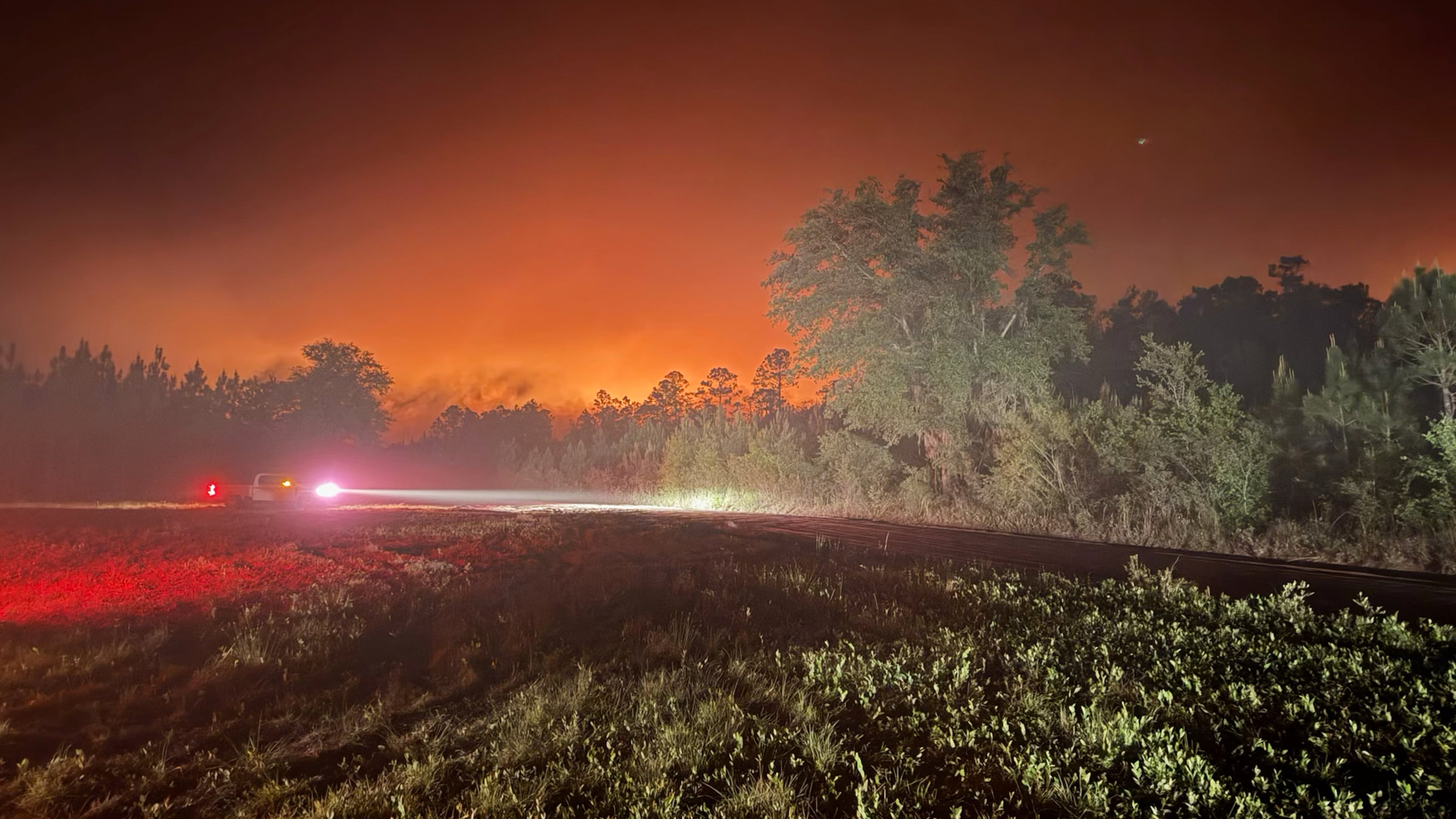 This photo provided by the Georgia Department of Natural Resources shows firefighters responding to the Pineland Road Fire in South Georgia on Monday, April 20, 2026. (Georgia Department of Natural Resources via AP)