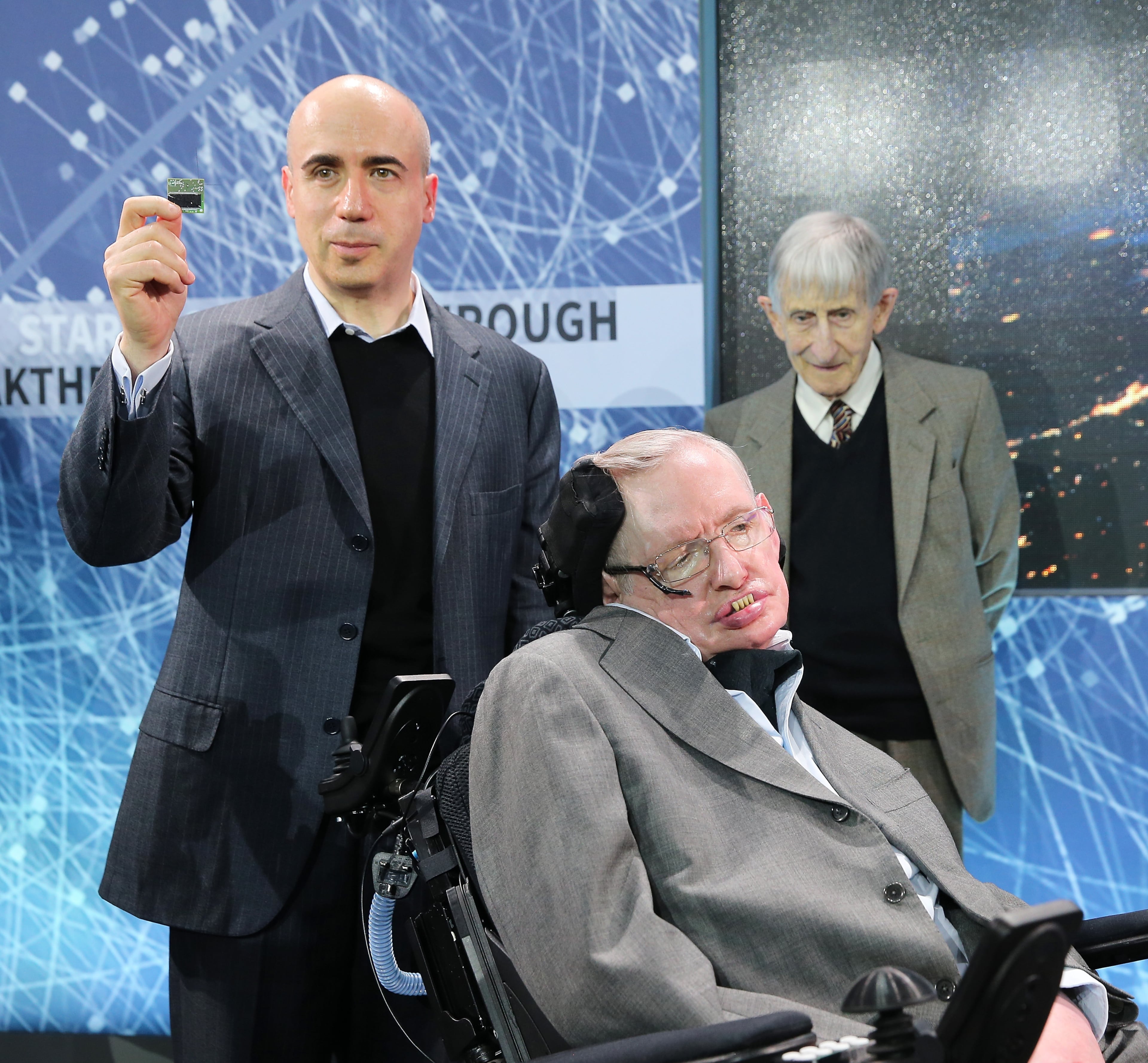 NEW YORK, NEW YORK - APRIL 12: Scientist and investor Yuri Milner holds up a prototype of the "Star Chip", a small robotic space craft that will enable intersteller space travel as he poses with Professor Stephen Hawking at the New Space Exploration Initiative "Breakthrough Starshot" Announcement at One World Observatory on April 12, 2016 in New York City. (Photo by Jemal Countess/Getty Images)