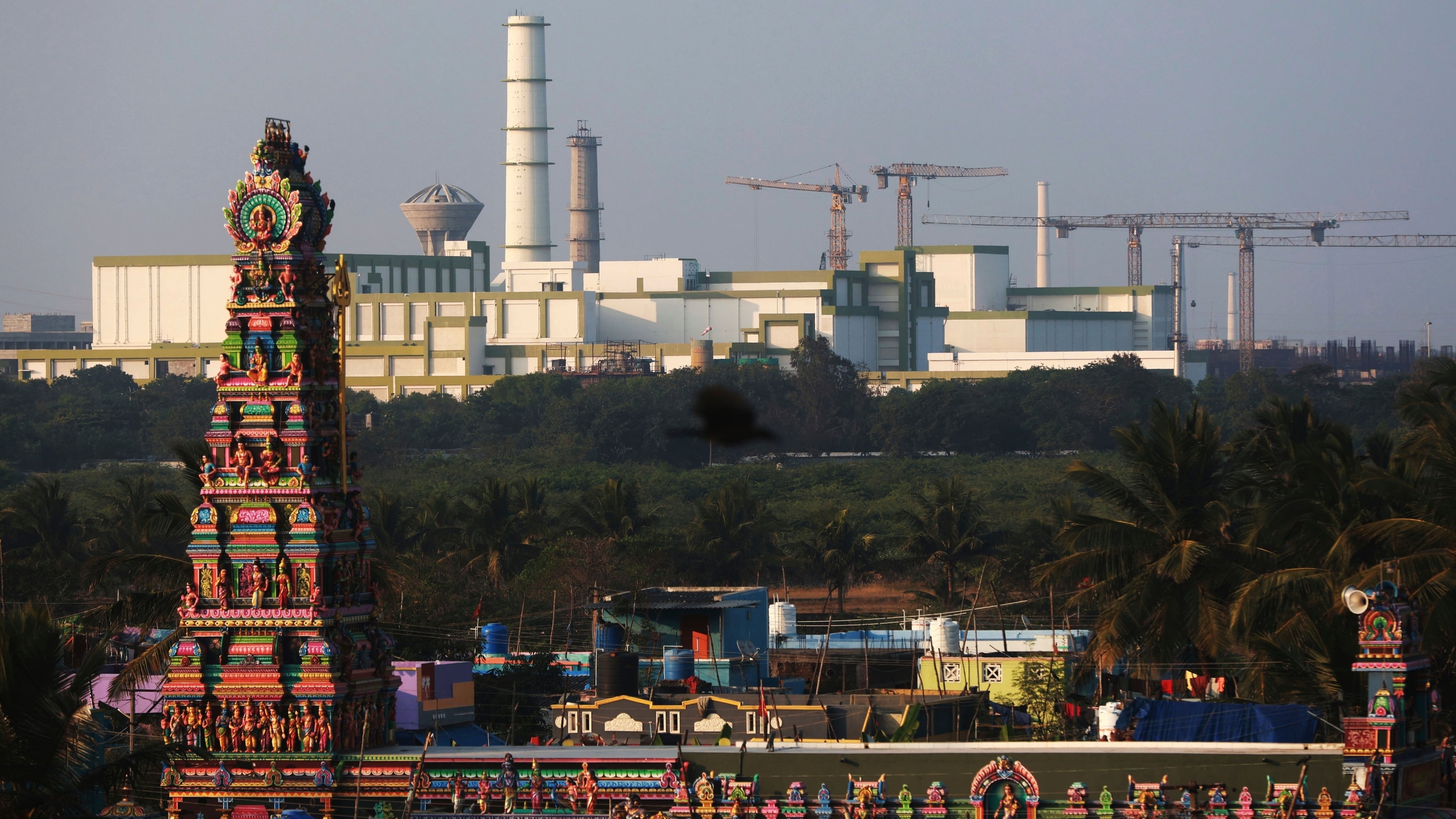 FILE - A temple stands in the foreground of the Madras Atomic Power Station located at Kalpakkam, in the Indian state of Tamil Nadu, Feb. 10, 2025. (AP Photo/R. Parthibhan, File)