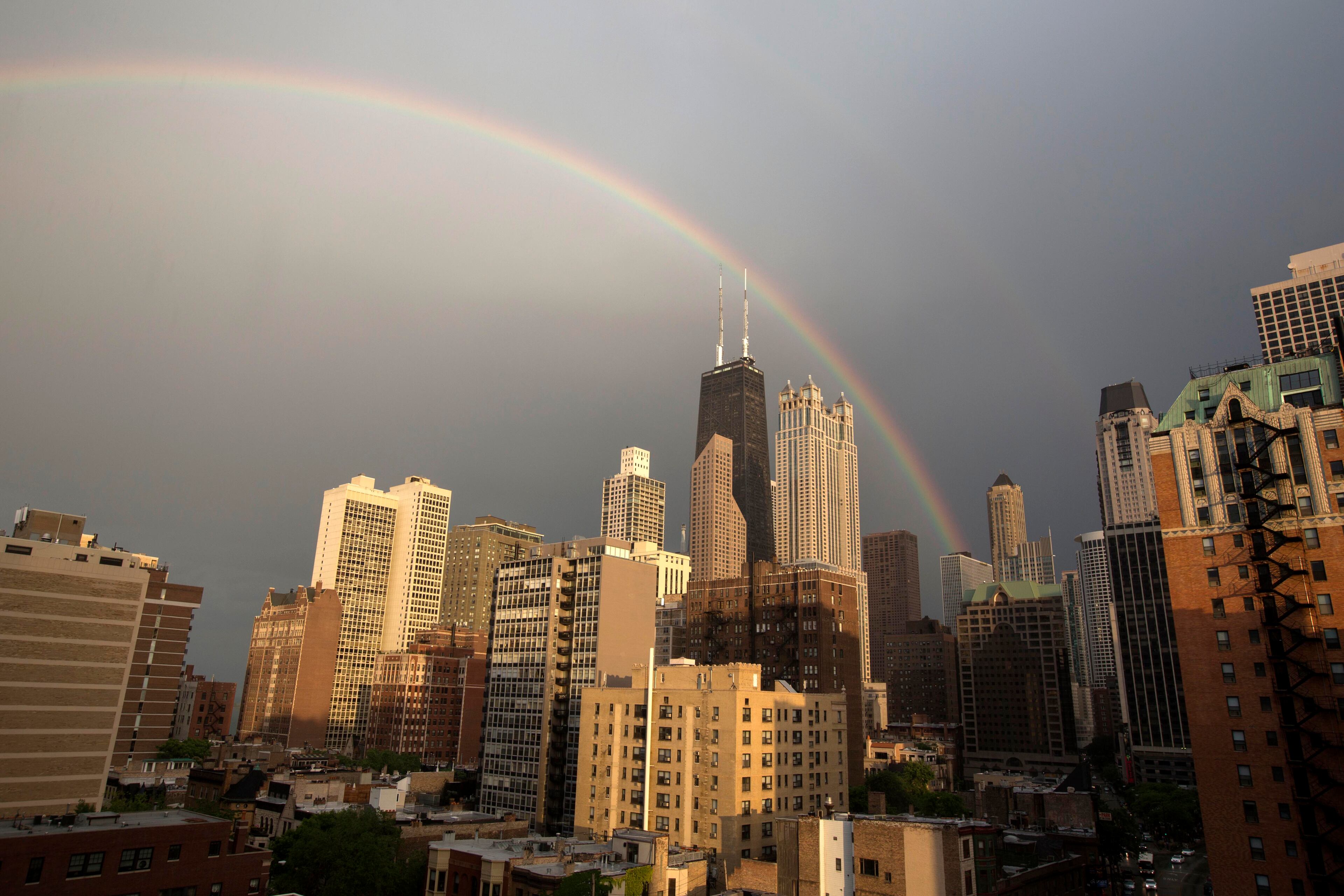 A rainbow appears over Chicago after a quick rain shower, Monday, June 17, 2013. (AP Photo/Scott Eisen)
