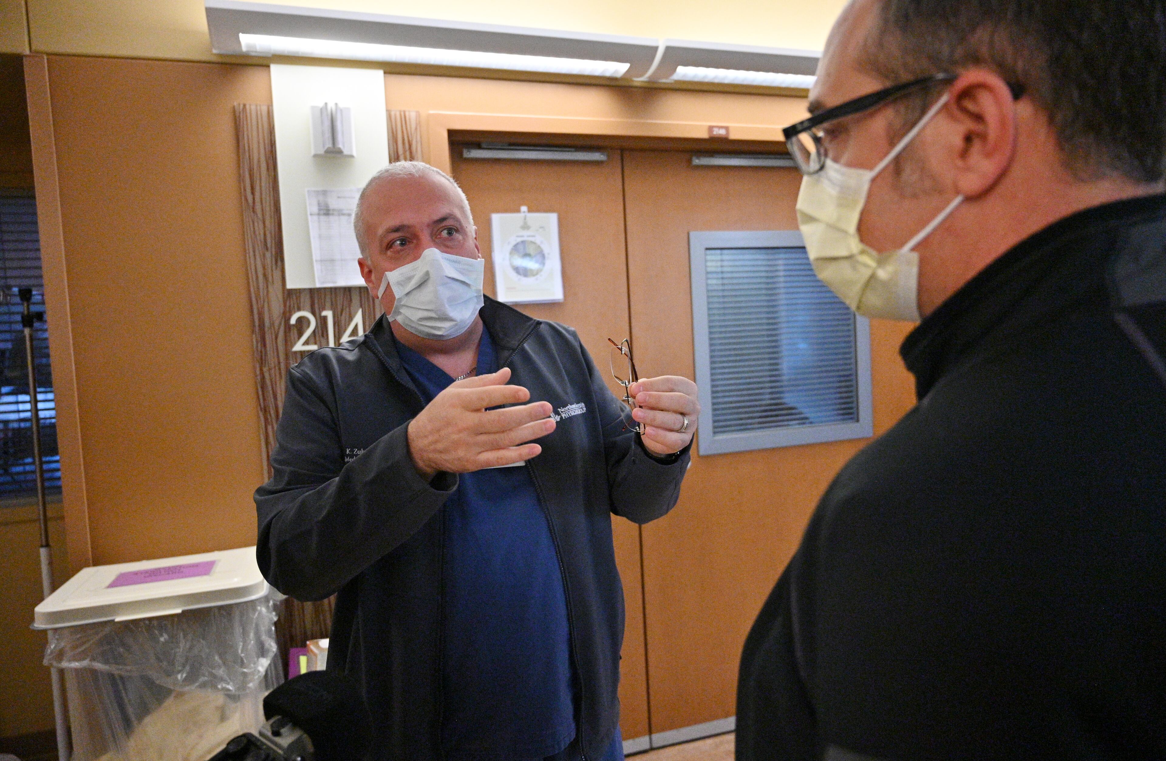 Dr. Konstantin Zubelevitskiy, left, talks to Dr. Hisham Qutob, both Critical Care doctors, at the Intensive Care Unit. "I think I've learned to deal it with better. It doesn't help to worry about things you can not change, you kind of develop a philosophical approach," he said. (Hyosub Shin / Hyosub.Shin@ajc.com)