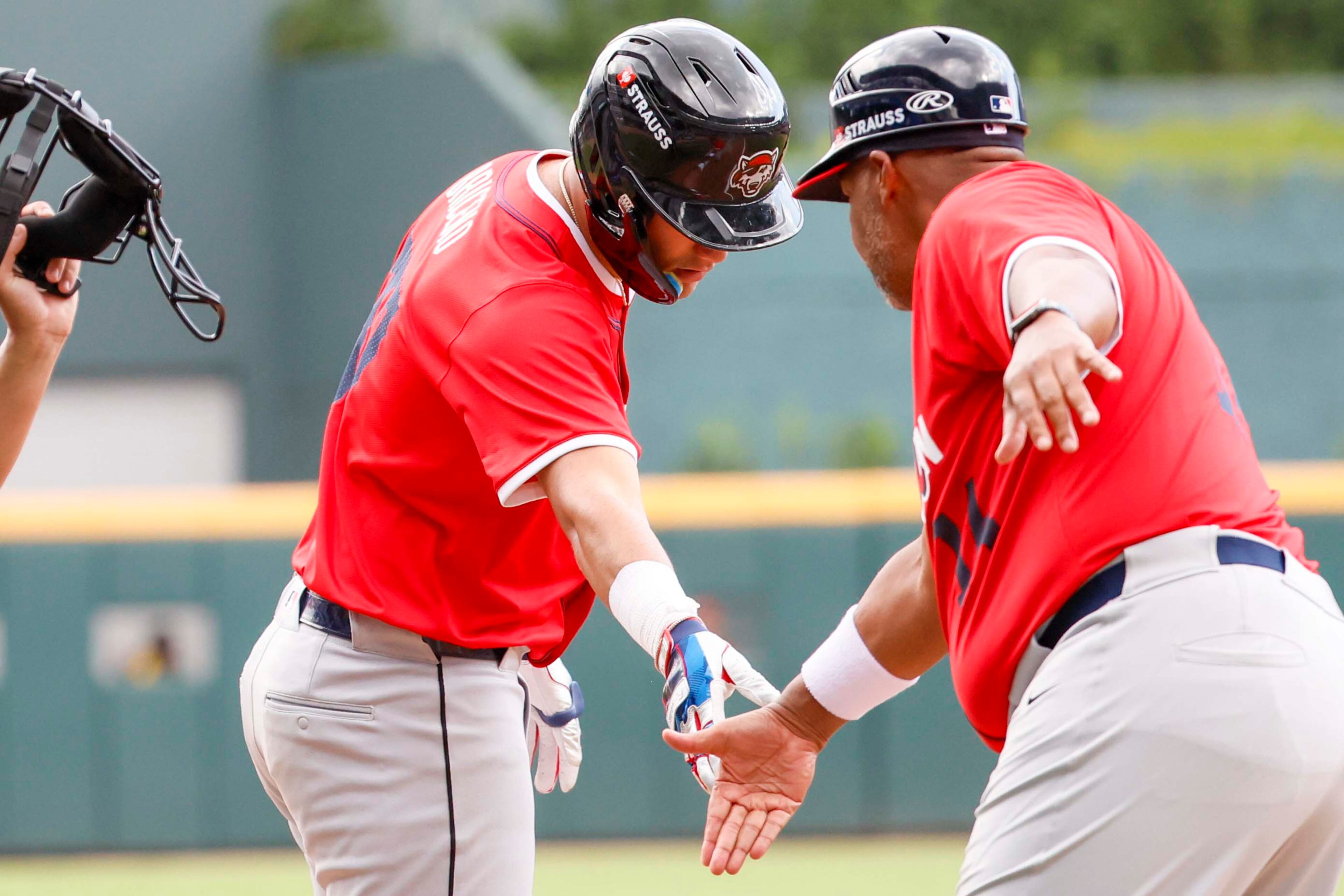 American League catcher Josue Briceno (37) of the Detroit Tigers high fives American League third base coach Brian Hunter after his tripple during the MLB All-Star Futures Game at Truist Park on Saturday, July 12, 2025, in Atlanta.
(Miguel Martinez/ AJC)