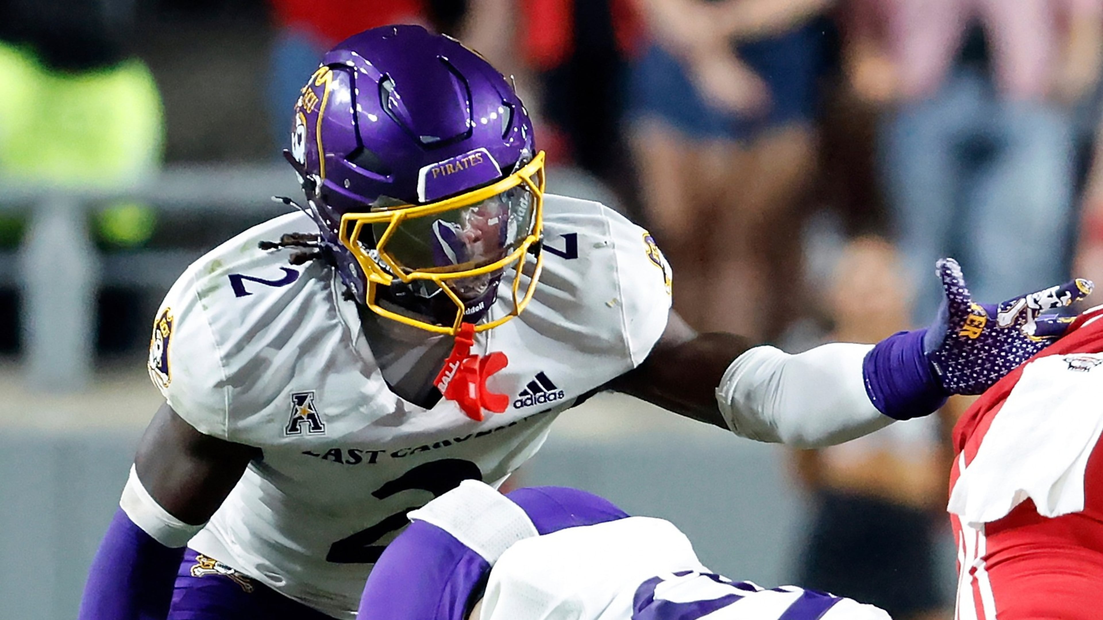 FILE - East Carolina's Ja'Marley Riddle (2) helps with a tackle during the second half of an NCAA college football game against North Carolina State in Raleigh, N.C., Aug. 28, 2025. (AP Photo/Karl DeBlaker, File)
