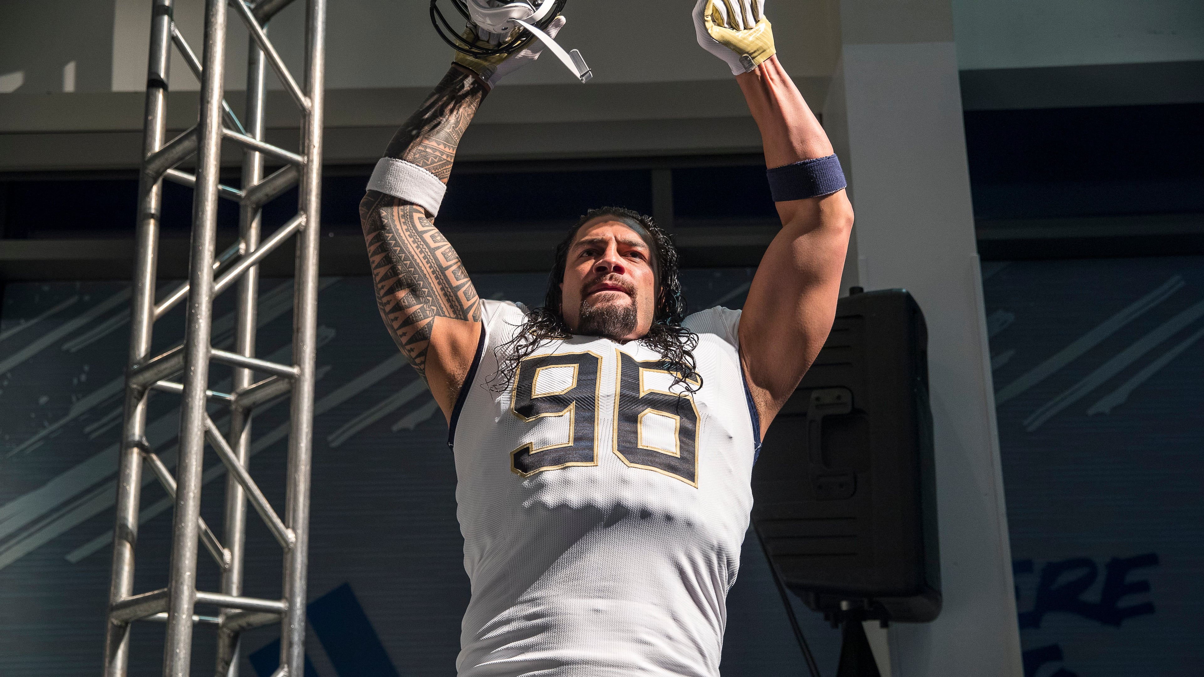 Professional wrestler and former Georgia Tech football player Roman Reigns models the new football uniforms during a reveal party in Atlanta, Friday, August 3, 2018. (ALYSSA POINTER/ALYSSA.POINTER@AJC.COM)