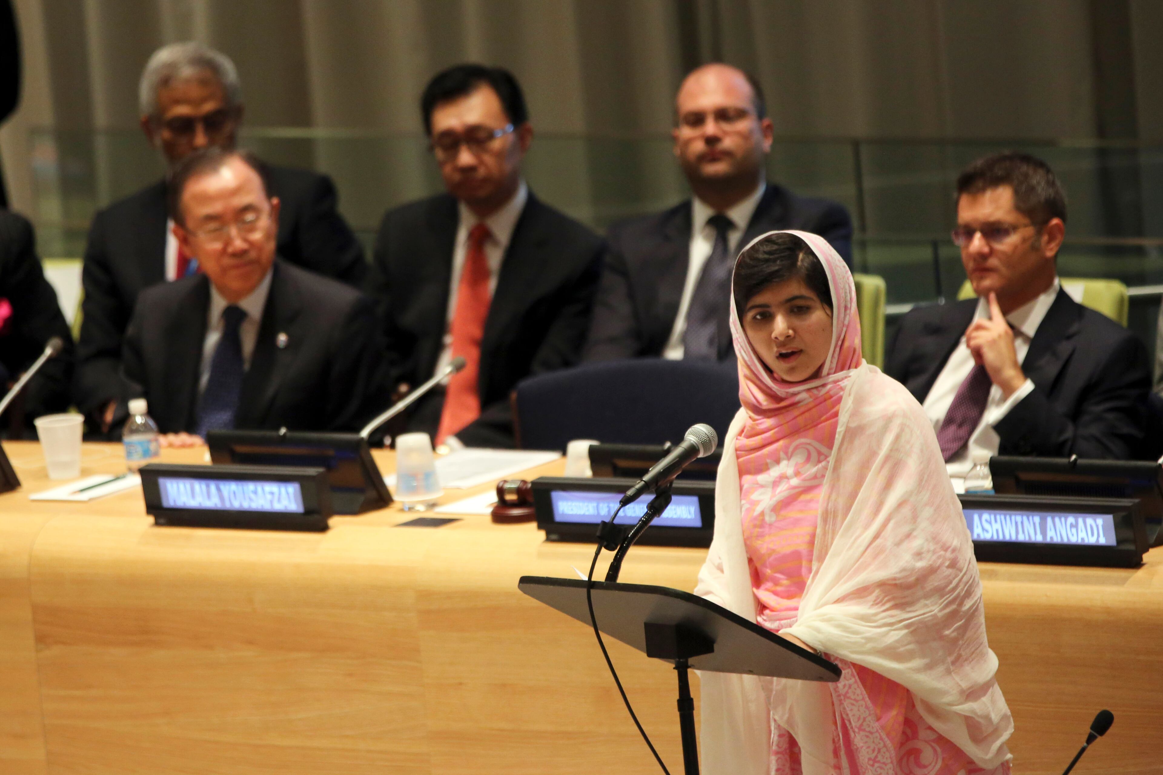United Nations Secretary-General Ban Ki-moon, left, listens as Malala Yousafzai, right, addresses the "Malala Day" Youth Assembly, at United Nations headquarters on July 12, 2013.