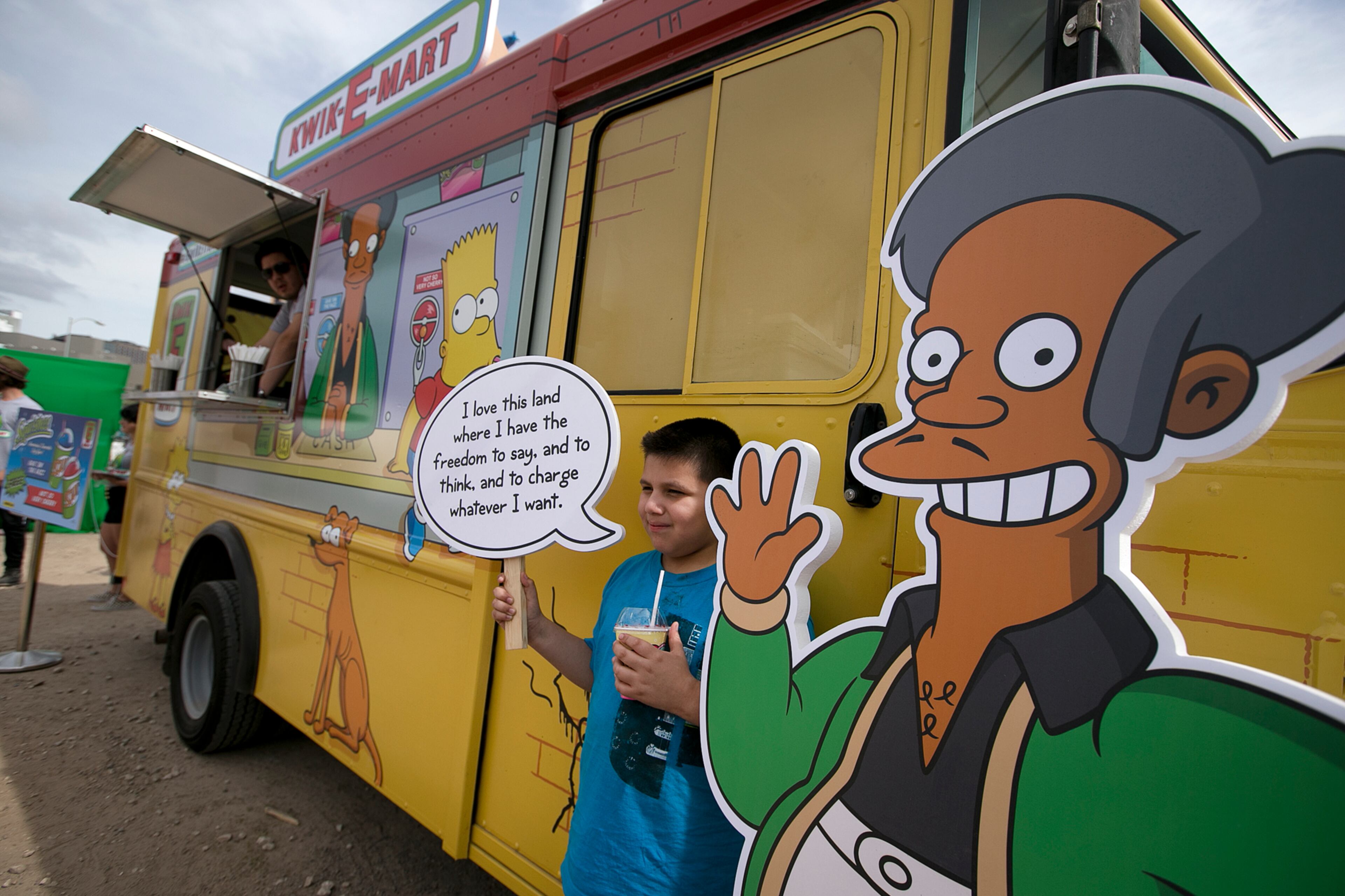 Migael Pimentel, 9, holds up an Apu saying as he has his photo taken at the Simpsons Kwik-E-Mart Truck at South Bites Food during SXSW at the Austin Convention Center on Sunday, March 15, 2015. DEBORAH CANNON / AMERICAN-STATESMAN