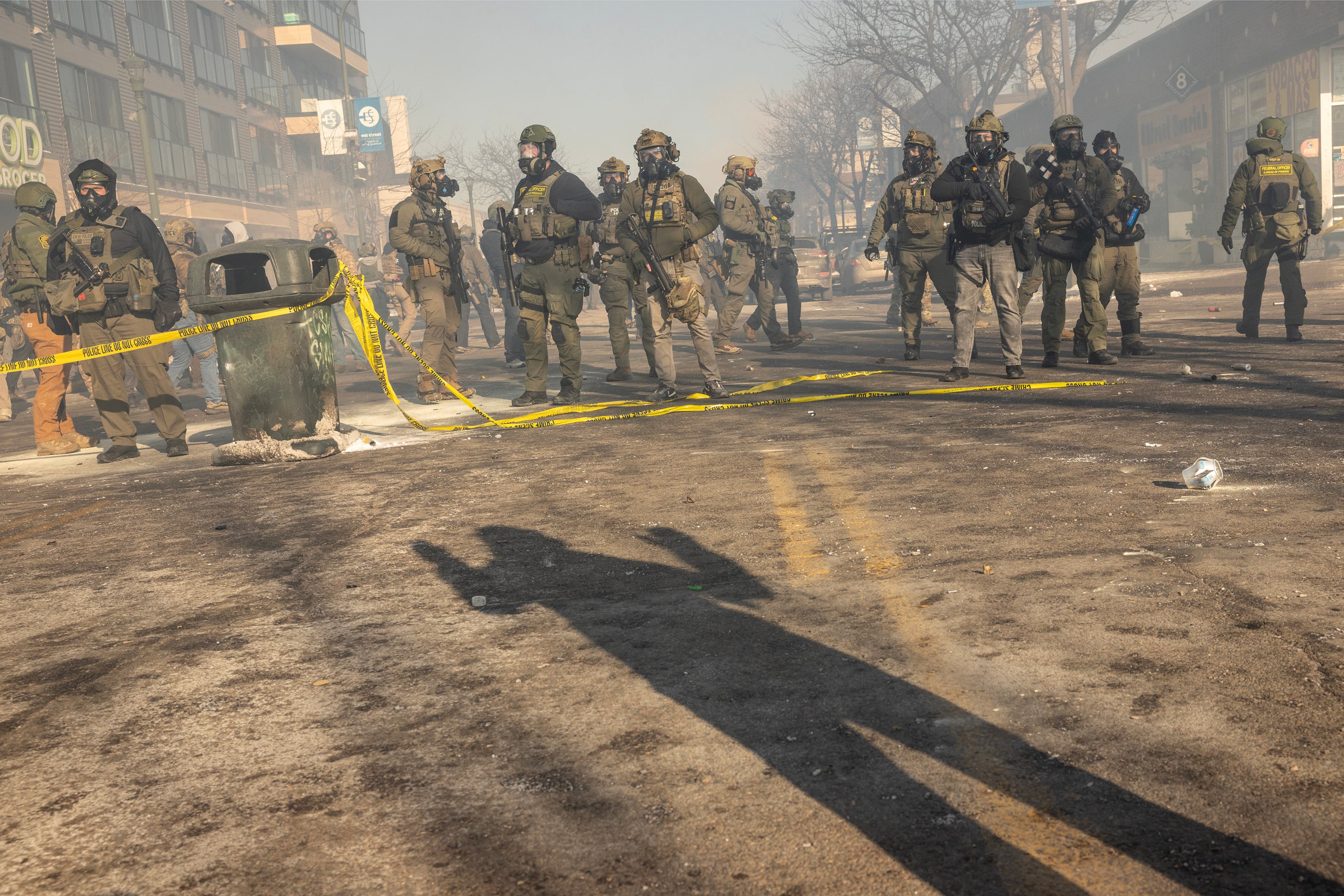 Federal agents stand near the site where federal agents shot and killed Alex Jeffrey Pretti, a 37-year-old Minneapolis resident, in Minneapolis on Saturday, Jan. 24, 2026. Pretti, was a registered nurse who worked in the intensive-care unit at the Veterans Affairs hospital in Minneapolis, public records show, and lived in an apartment in Minneapolis a short drive away from where he was killed. (David Guttenfelder/The New York Times)