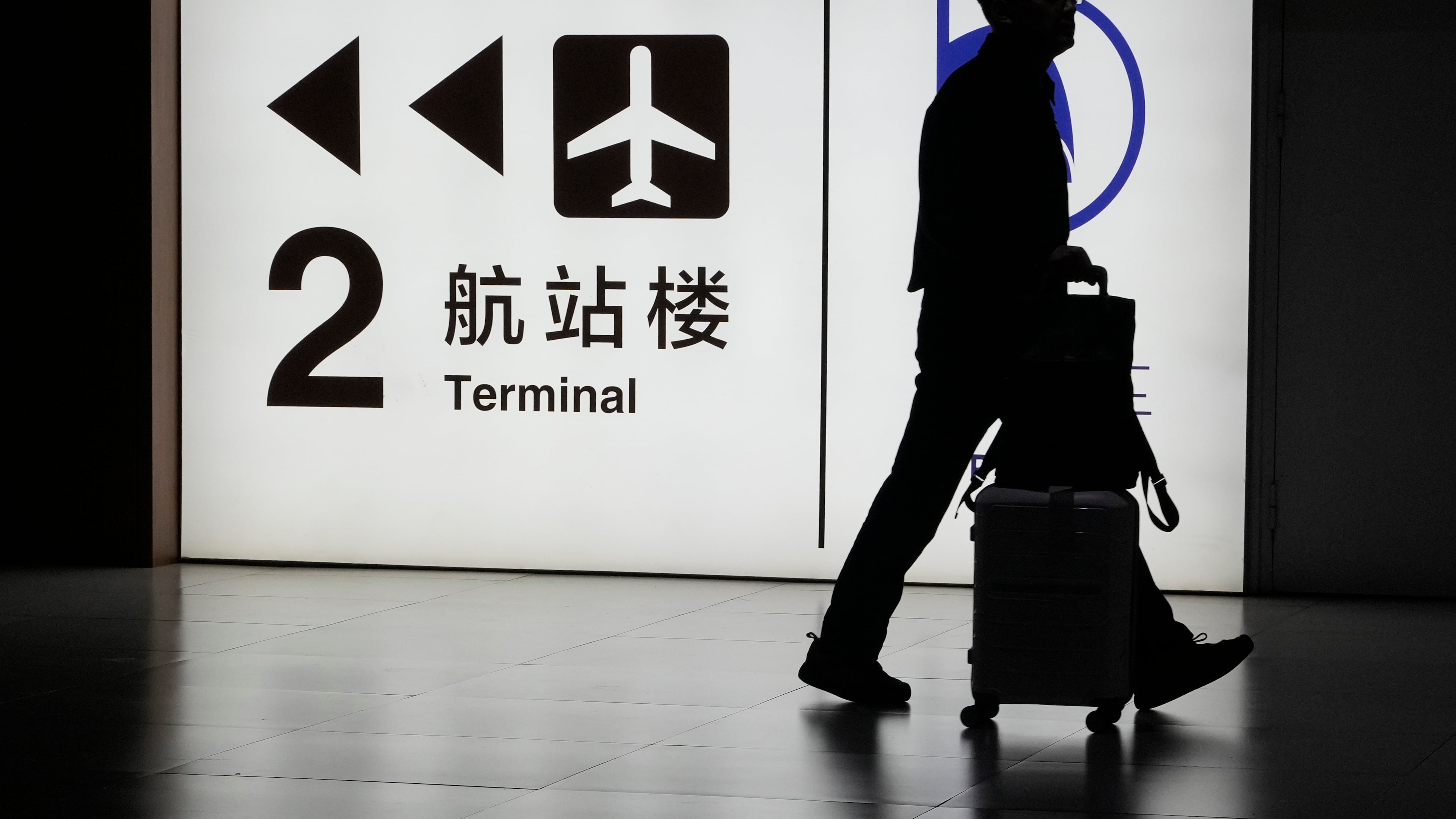 FILE - A passenger arrives at the Capital Airport in Beijing on Nov. 7, 2025. (AP Photo/Ng Han Guan, file)