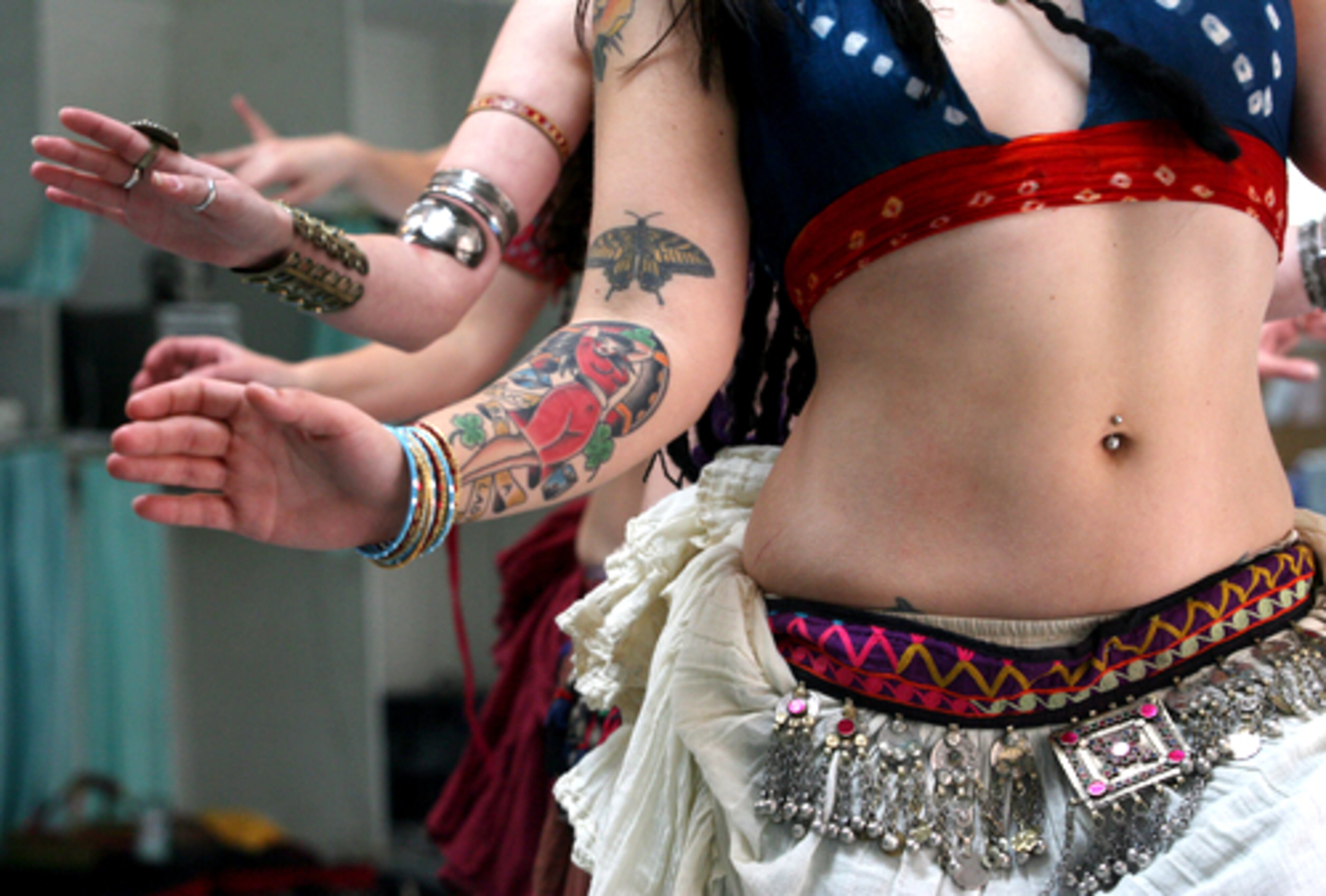 Sisson demonstrates tribal moves. To reflect personal style, dancers accessorize their costumes with jewelry, belts and items from around the world.