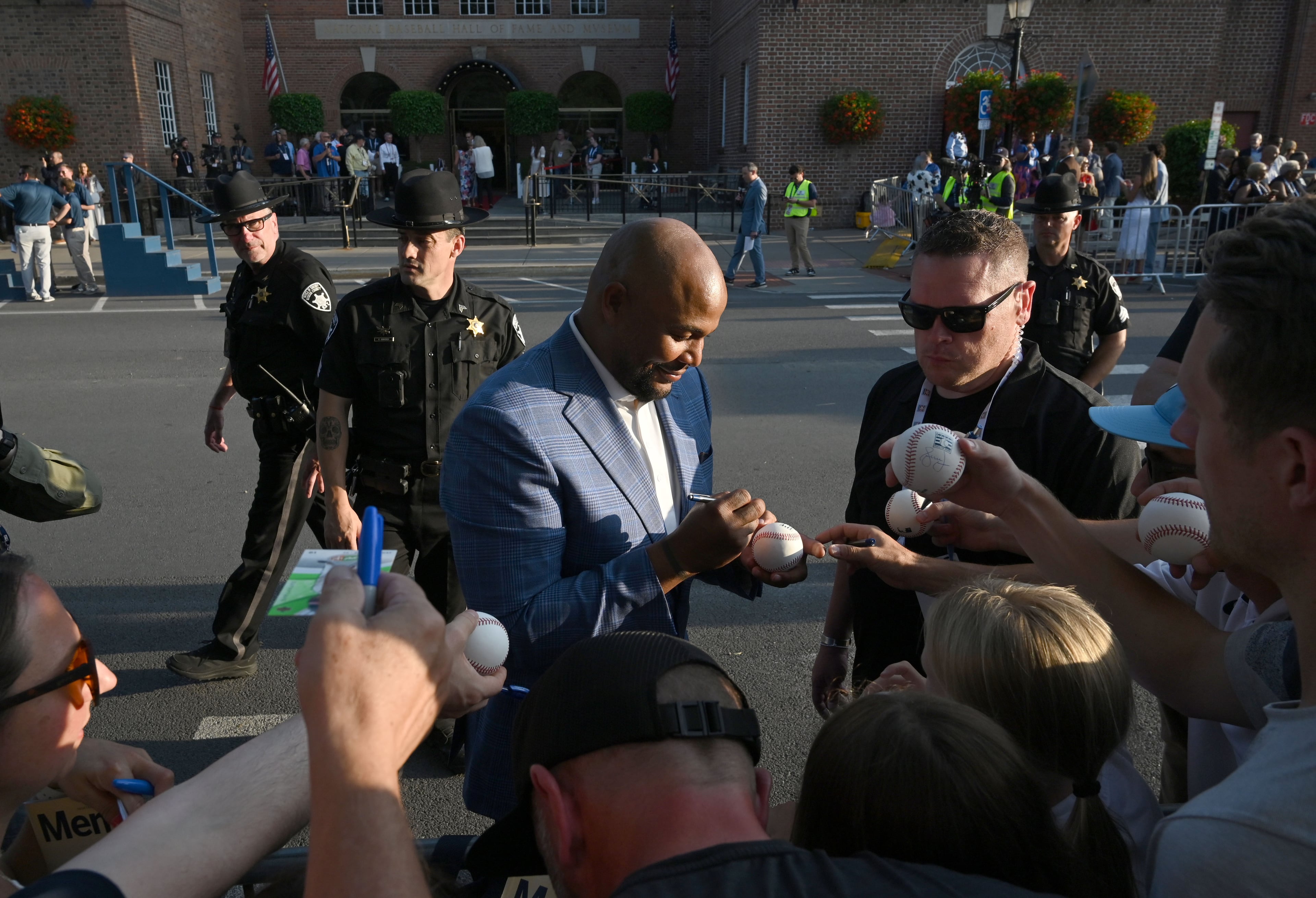 Former Brave Andruw Jones signs autographs during the Hall of Fame Legends Parade on Saturday, July 25, 2026, in Cooperstown, N.Y. (Hyosub Shin/AJC)