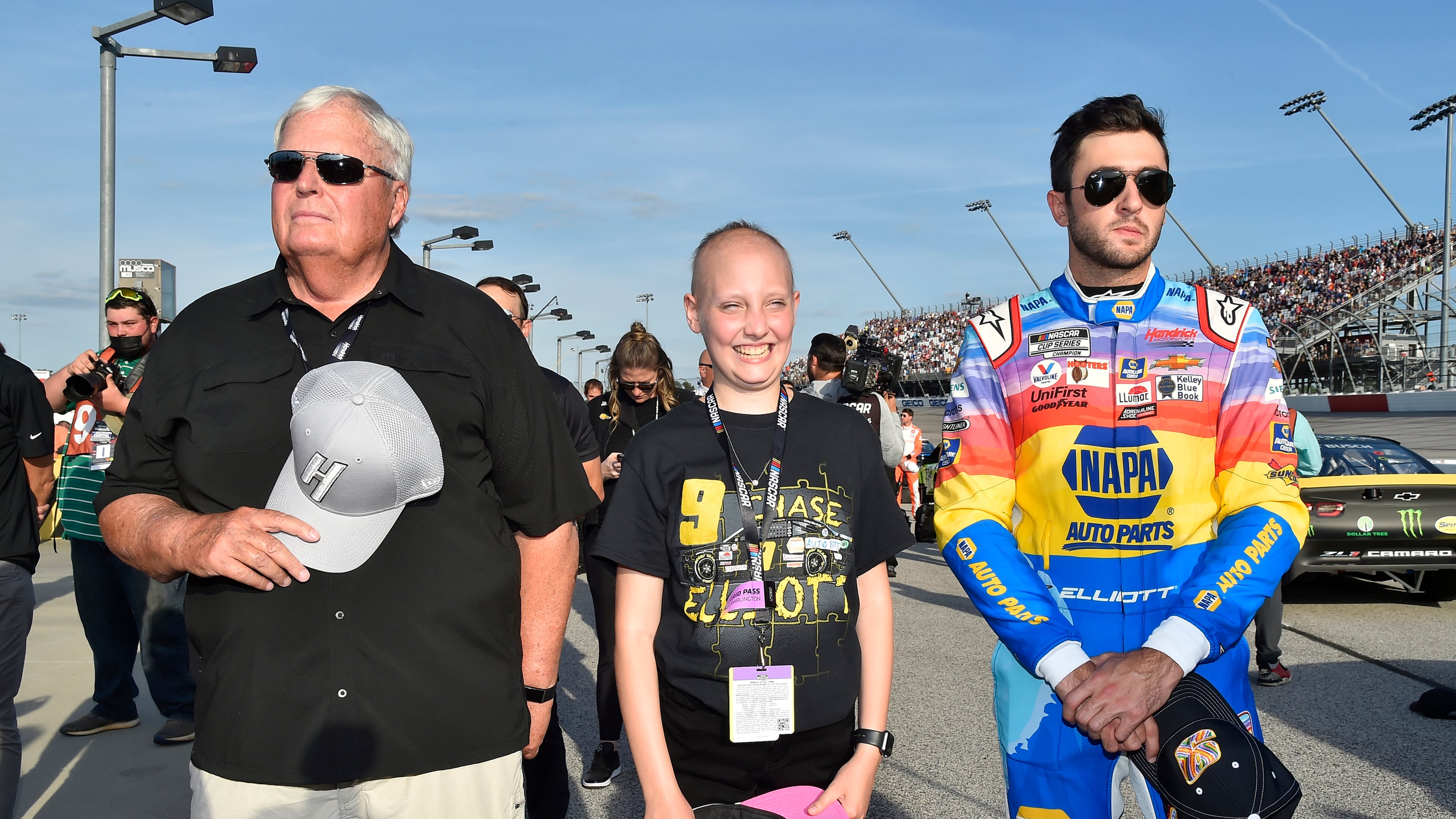 Mary Webb stands with NASCAR driver Chase Elliott and team owner Rick Hendrick before the Southern 500 at Darlington Speedway on Sept. 5, 2021. (Courtesy of Children's Healthcare of Atlanta)