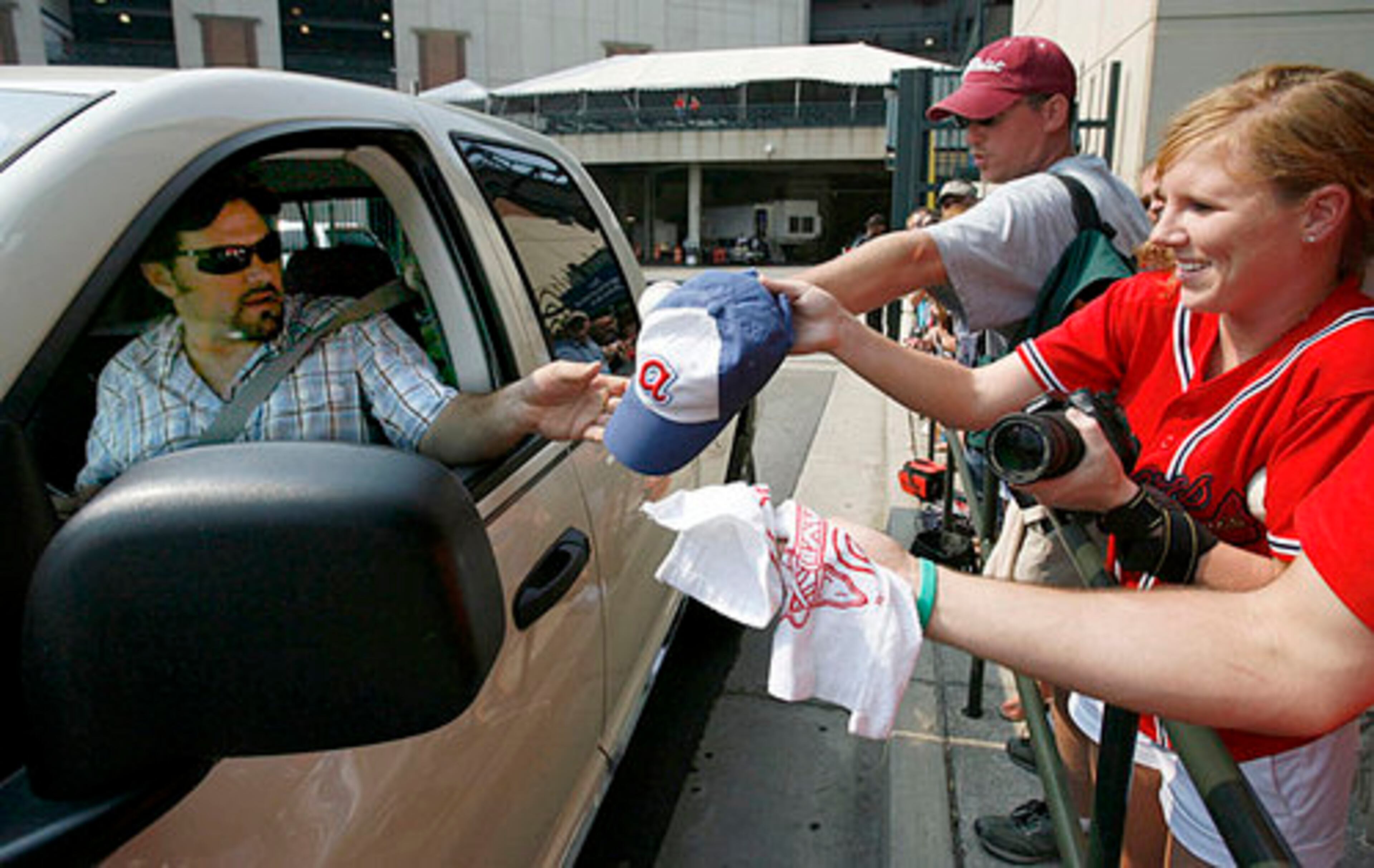 You can always wait for later. Catcher Miller signs an autograph from his truck for fan Cassi Wiggins as he exits the players' parking lot -- one of ony four players to do so on that day. Fans line up along a gate in hopes of players' stopping to sign autographs for them. The line starts around the seventh inning.