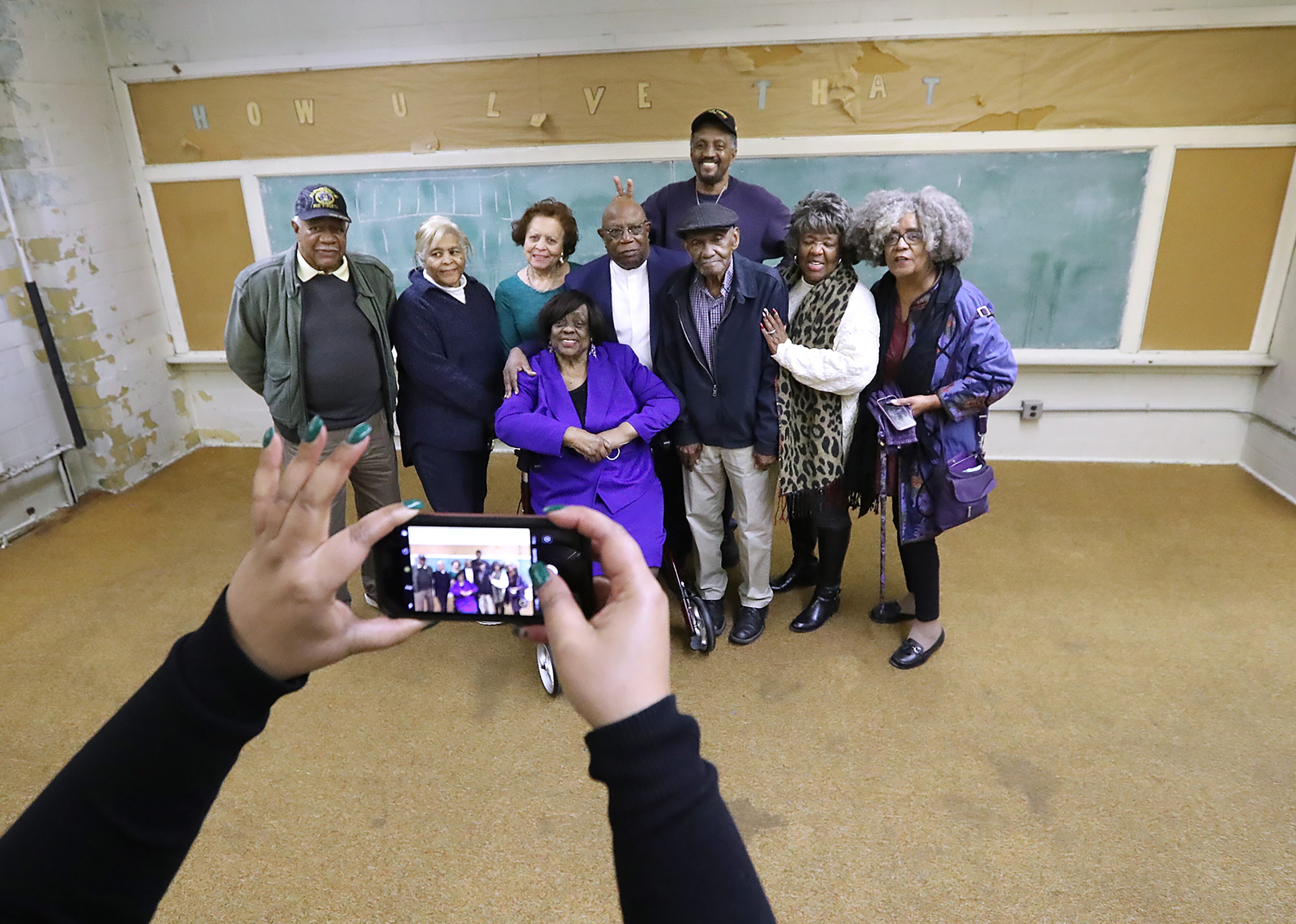 December 3, 2019 Marietta: Angela Orange snaps a photo of former teachers and students that returned to participate in the Lemon Street Grammar School tour and reception on Tuesday, December 3, 2019, in Marietta. The historically black elementary school was closed once the city school system was integrated. Curtis Compton/ccompton@ajc.com