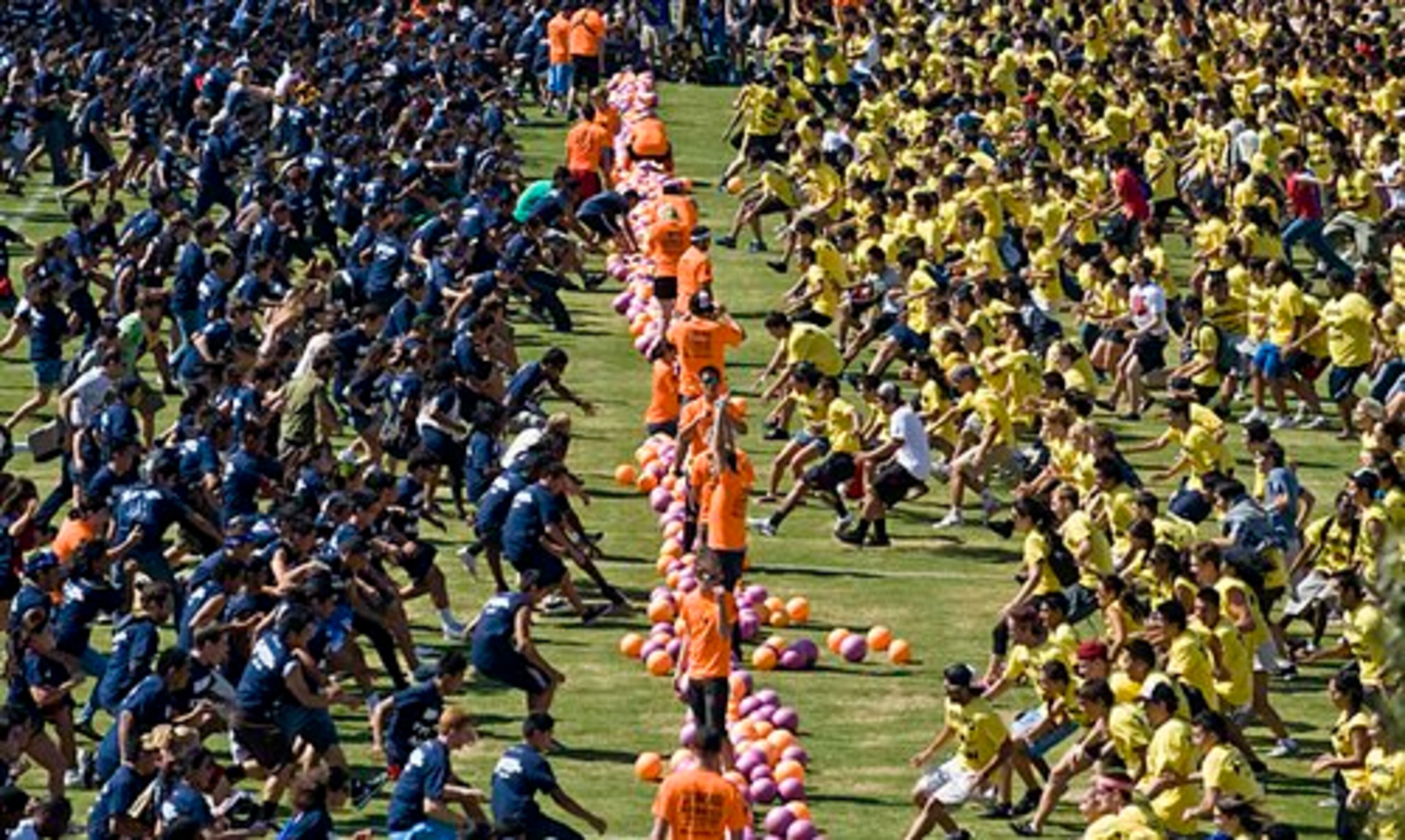Divided into two teams, over 4,000 students at the University of California-Irvine rush to a line of balls at the Anteater Recreation Center Fields to launch their attempt to retake the Guinness world record for the largest dodgeball game.
