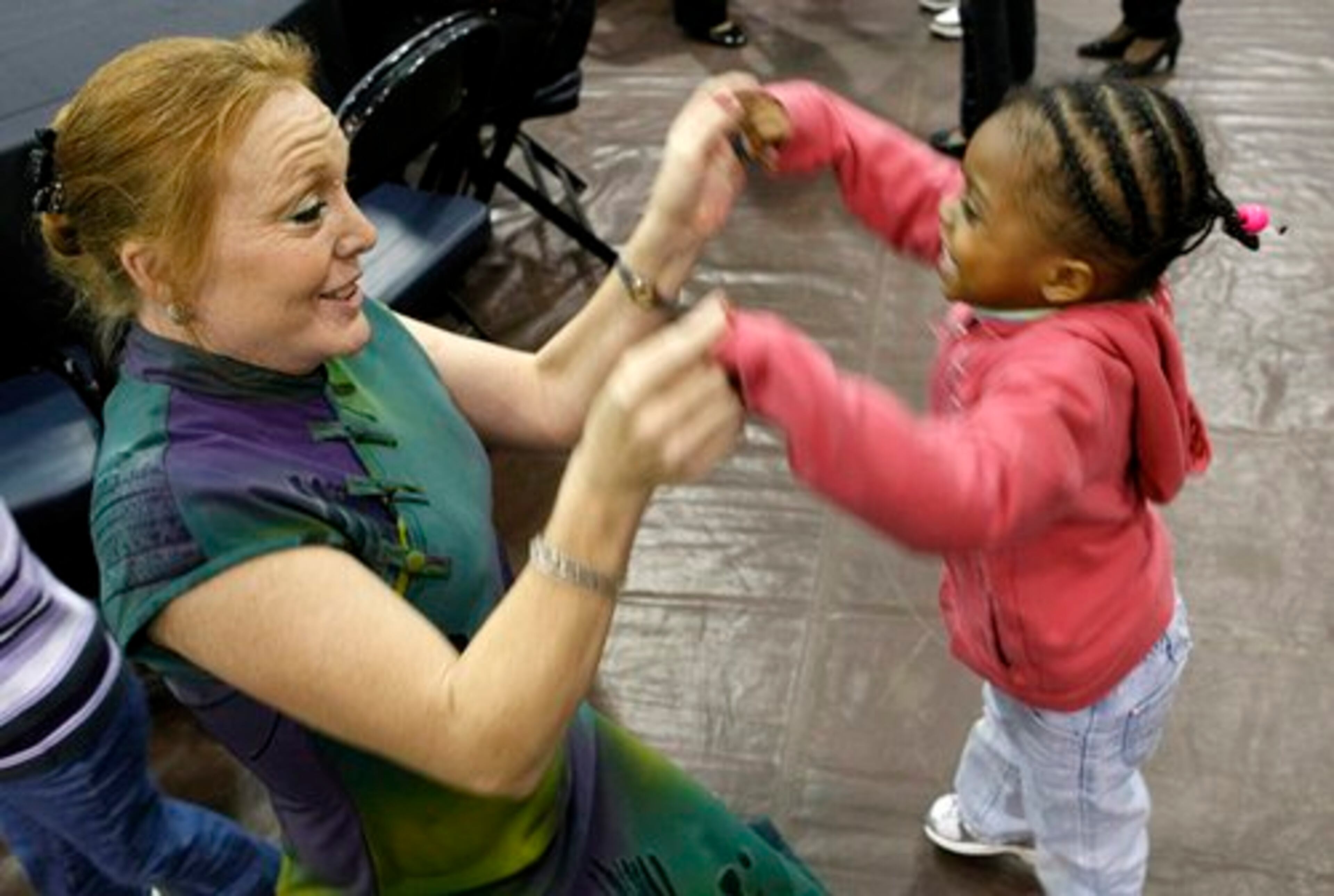 My Sister's House resident Theresa Portwood dances with fellow resident Ashley Jewell, 3,.