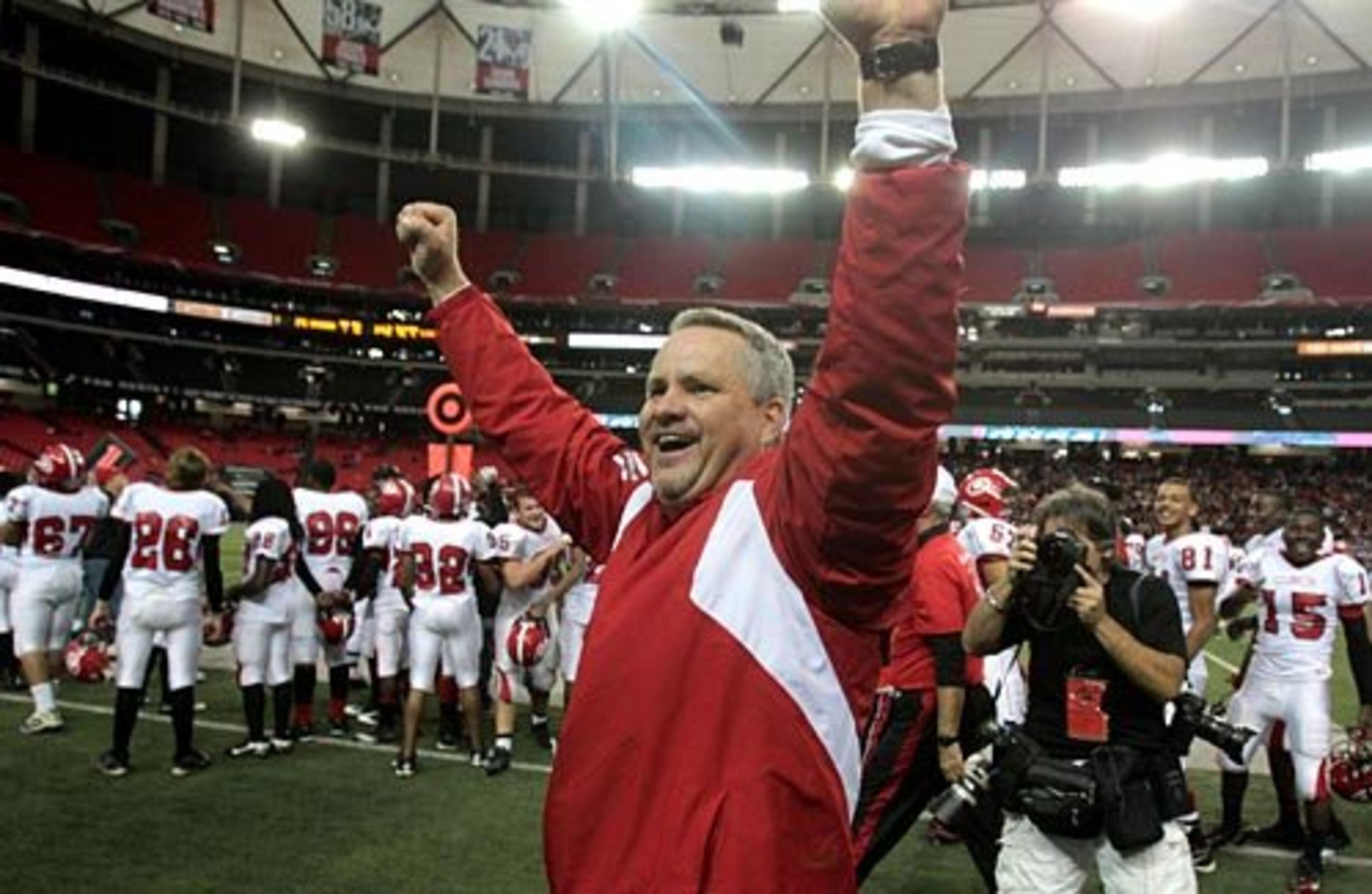 Clinch County coach Jim Dickerson celebrates with fans in the closing minutes of their 24-14 win over Savannah Christian in the Class A final Saturday afternoon at the Georgia Dome in Atlanta, Ga., Dec. 11, 2010.