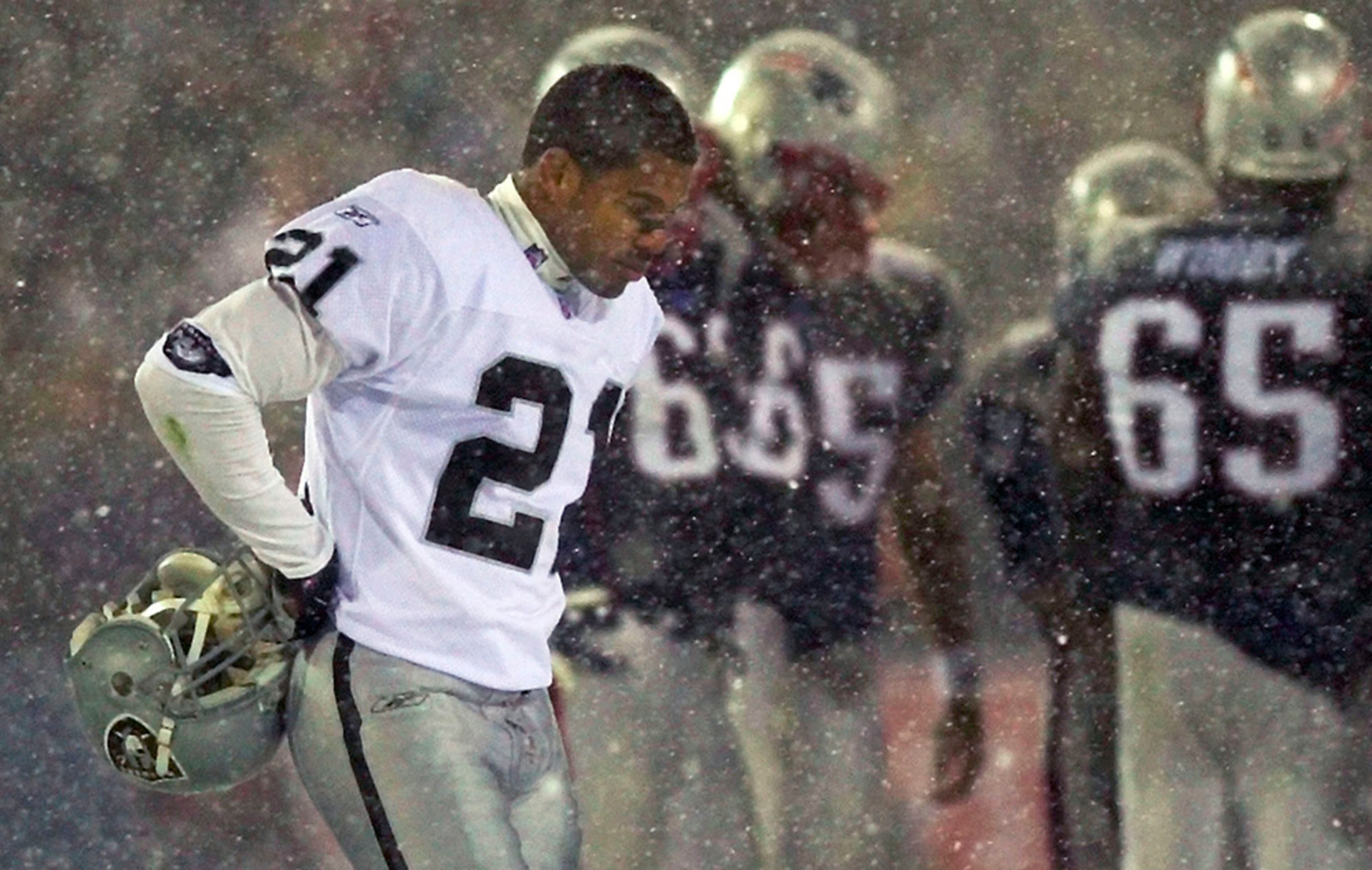 In the 2001 AFC divisional game at Foxboro Stadium, Raiders cornerback Charles Woodson sacks Patriots quarterback Tom Brady who loses the football recovered by Oakland. Initially ruled a fumble, the call is reversed after an instant-replay check with officials saying Brady had seemingly halted his passing motion and was attempting to "tuck" the ball back into his body. Officially ruled an anincomplete pass, the ball was given back to the Patriots, who subsequently moved the ball into field goal range and advanced to the AFC title game and eventually a Super Bowl win. The tuck rule was abolished in 2013.
