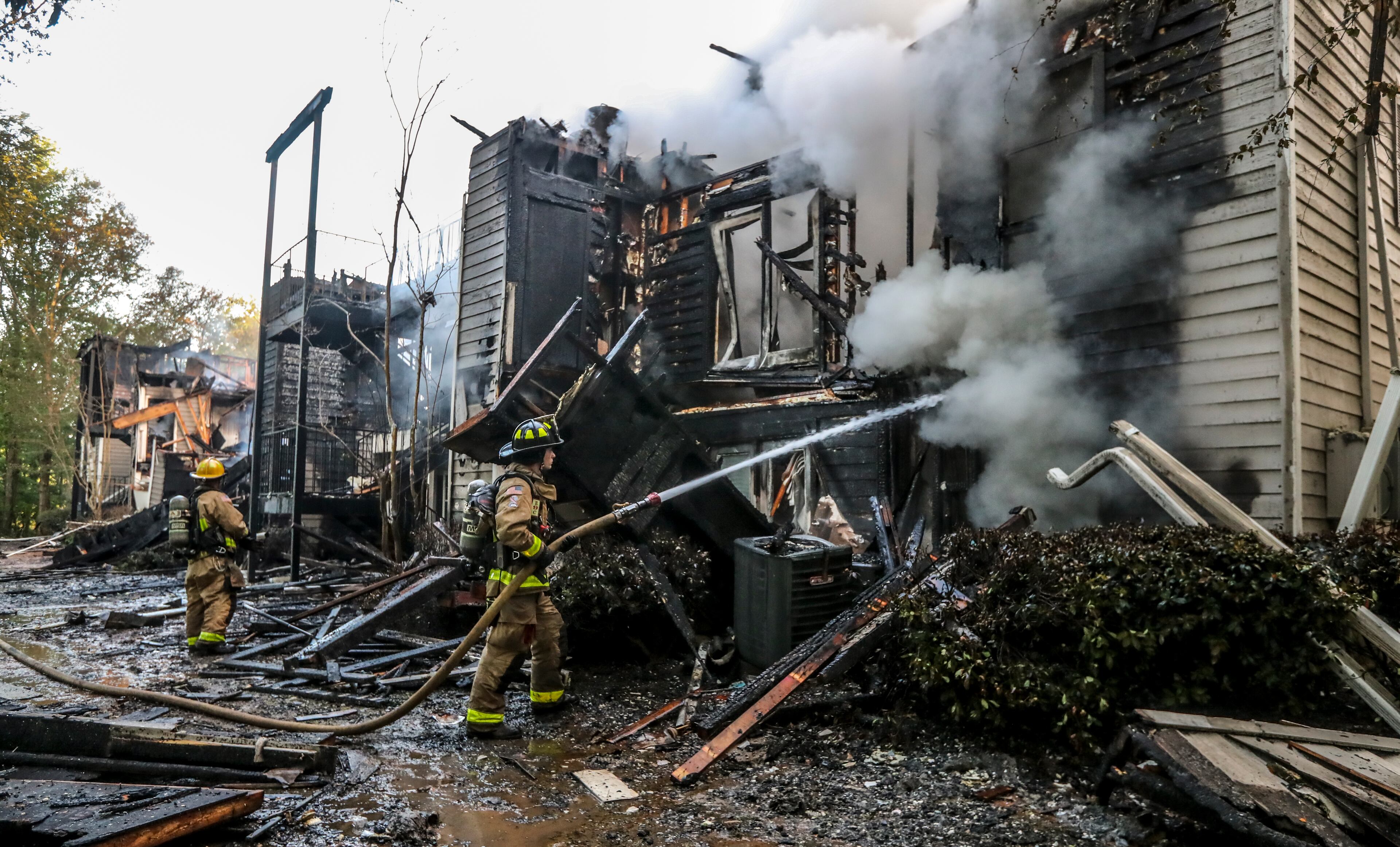 Cobb County fire crews worked through the early morning hours on Friday after nearly 60 people were displaced from the Lake Crossing Apartment Homes on Riverside Drive located at 1325 Riverside Parkway in Austel following a fire at the complex. (John Spink / John.Spink@ajc.com)