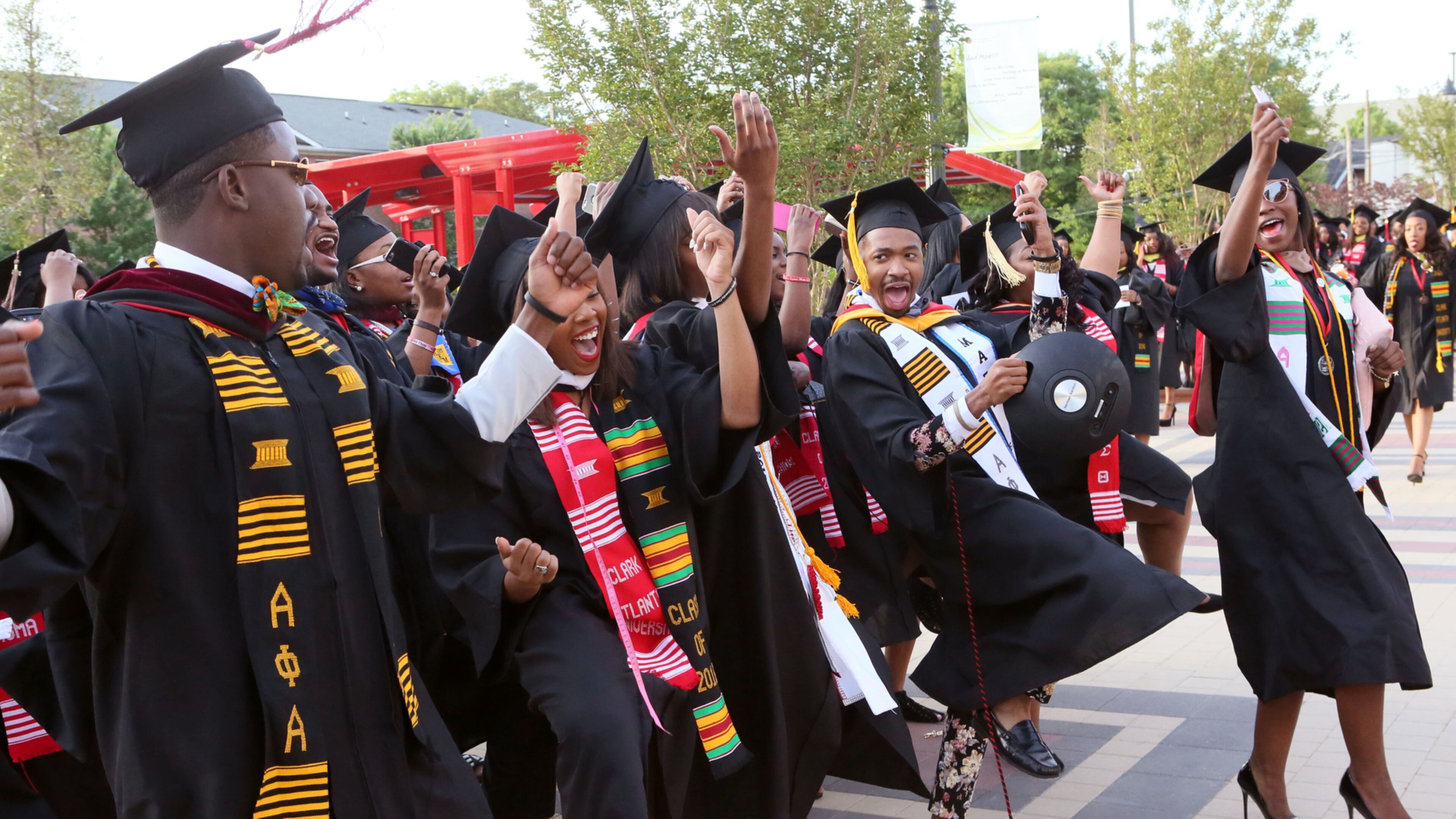 CLARK ATLANTA GRADS--May 16, 2016 - Atlanta - Graduates celebrate as they line up for the processional. Clark Atlanta University class of 2016 filled Panther Stadium Monday morning for it's 27th annual Commencement Service. The keynote speaker was retired astronaut Mae Jemison, the first woman of color in Space. Honorary degrees were awarded to Hamilton Bohannon, a 1964 graduate of Clark College; Roland Carter; Congressman John Conyers, and Congressman Hank Johnson, a 1976 Clark College graduate. BOB ANDRES / BANDRES@AJC.COM