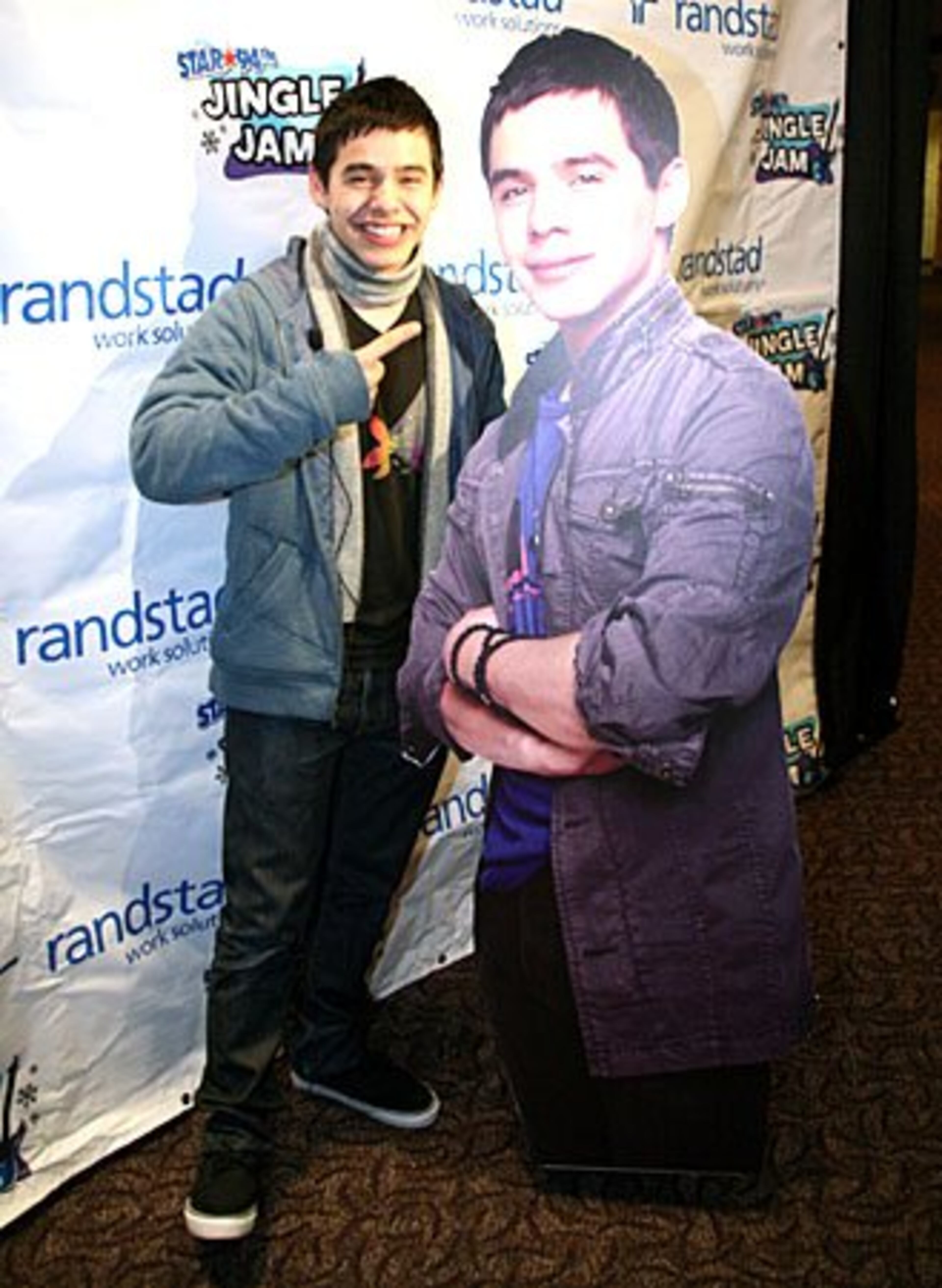 David Archuleta stands with his likeness in the lobby at Gwinnett Arena. Fans were able to snap their pictures standing next to cut-outs of each artist.