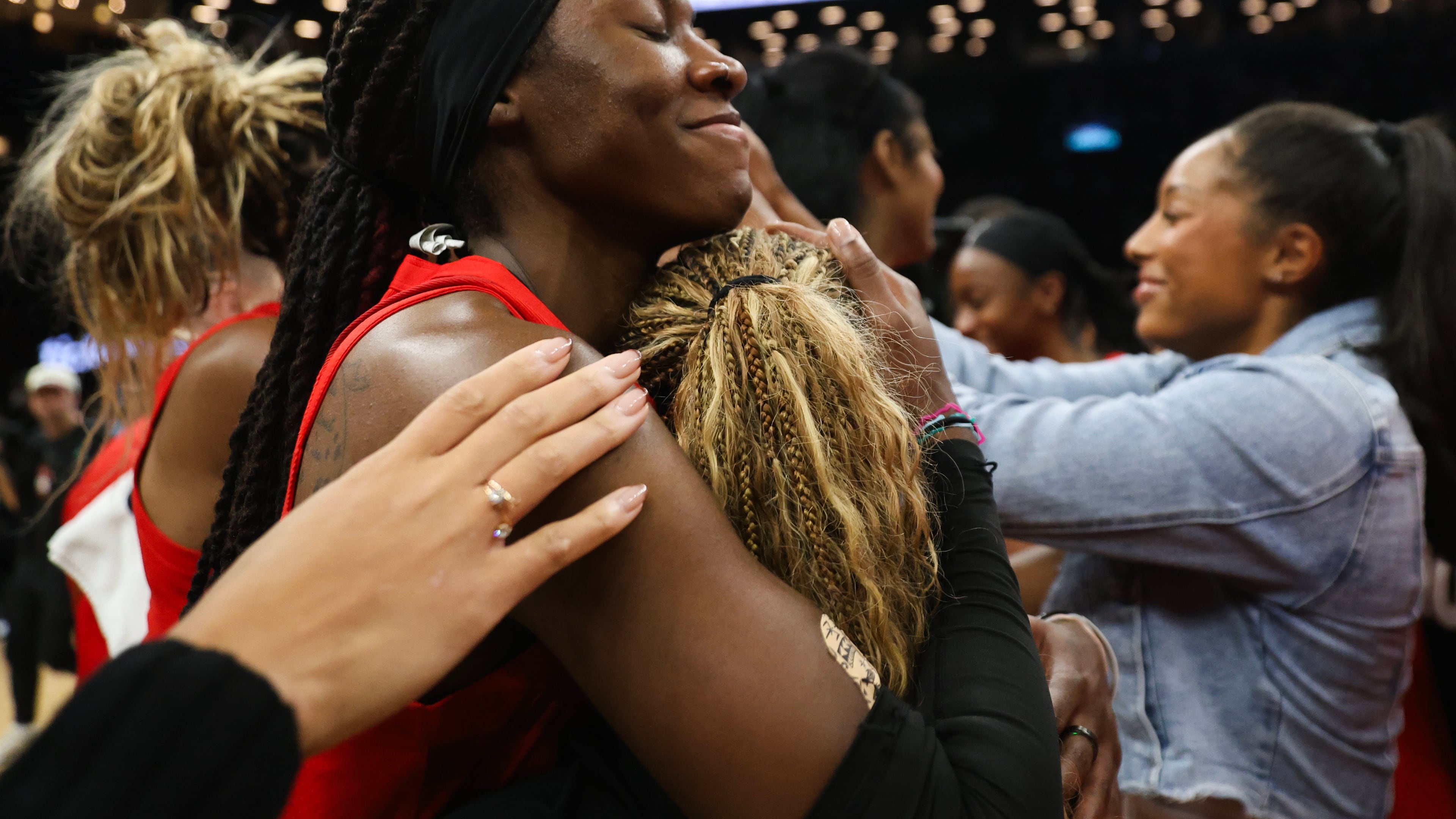 Atlanta Dream players, including Rhyne Howard, hug after defeating the New York Liberty in Game 3 of the WNBA basketball semifinals, Friday, Oct. 9, 2026, in New York. (Heather Khalifa/AP)
