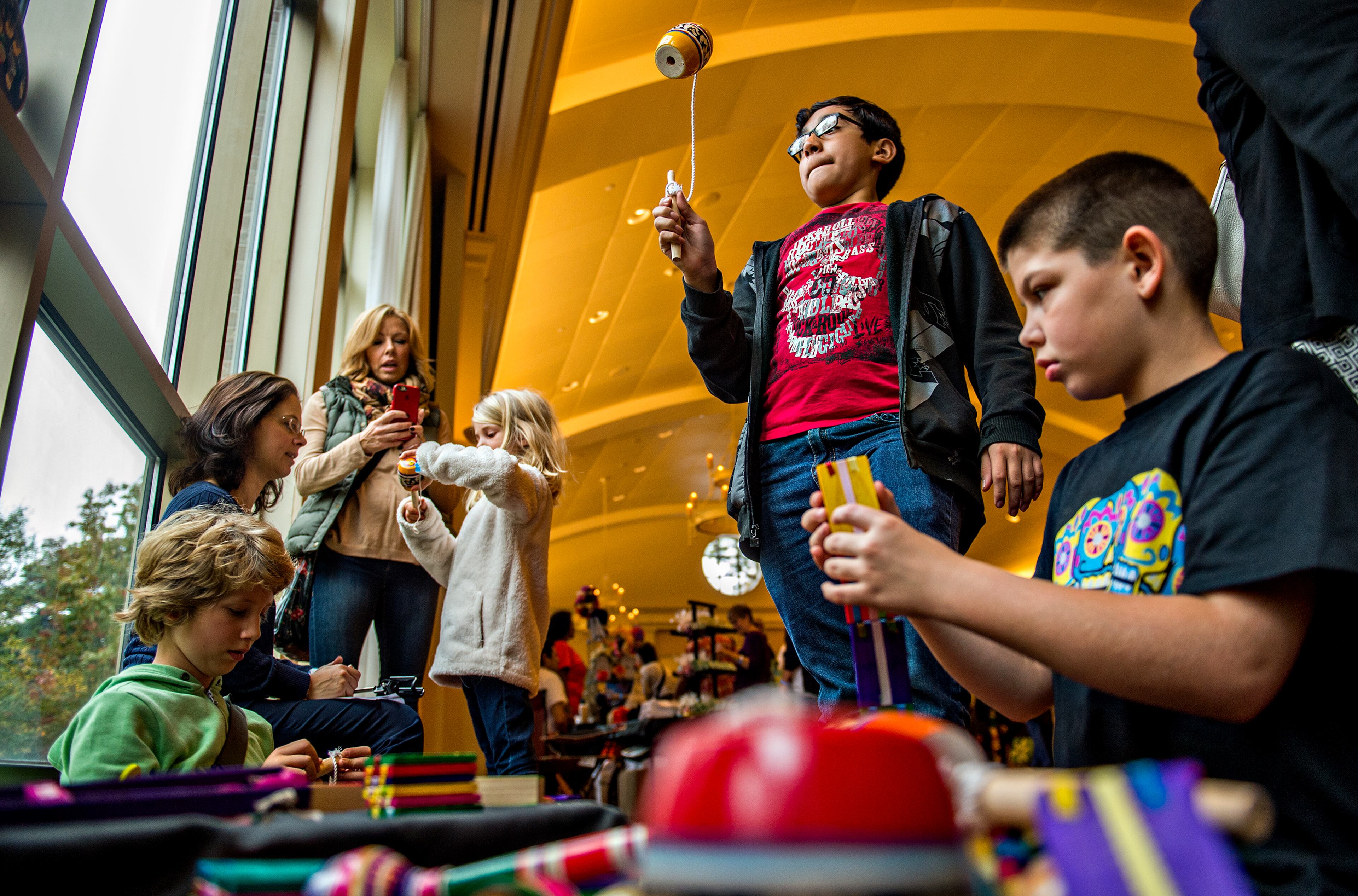November 1, 2015 Atlanta - Jose Martinez (center) plays with a traditional balero during the Dia De Muertos, or Day of the Dead, Festival at the Atlanta History Center on Sunday, November 1, 2015. The festival featured storytelling, crafts, and authentic Mexican food and entertainment while teaching about the day that traditionally honors dead friends and loved ones. JONATHAN PHILLIPS / SPECIAL