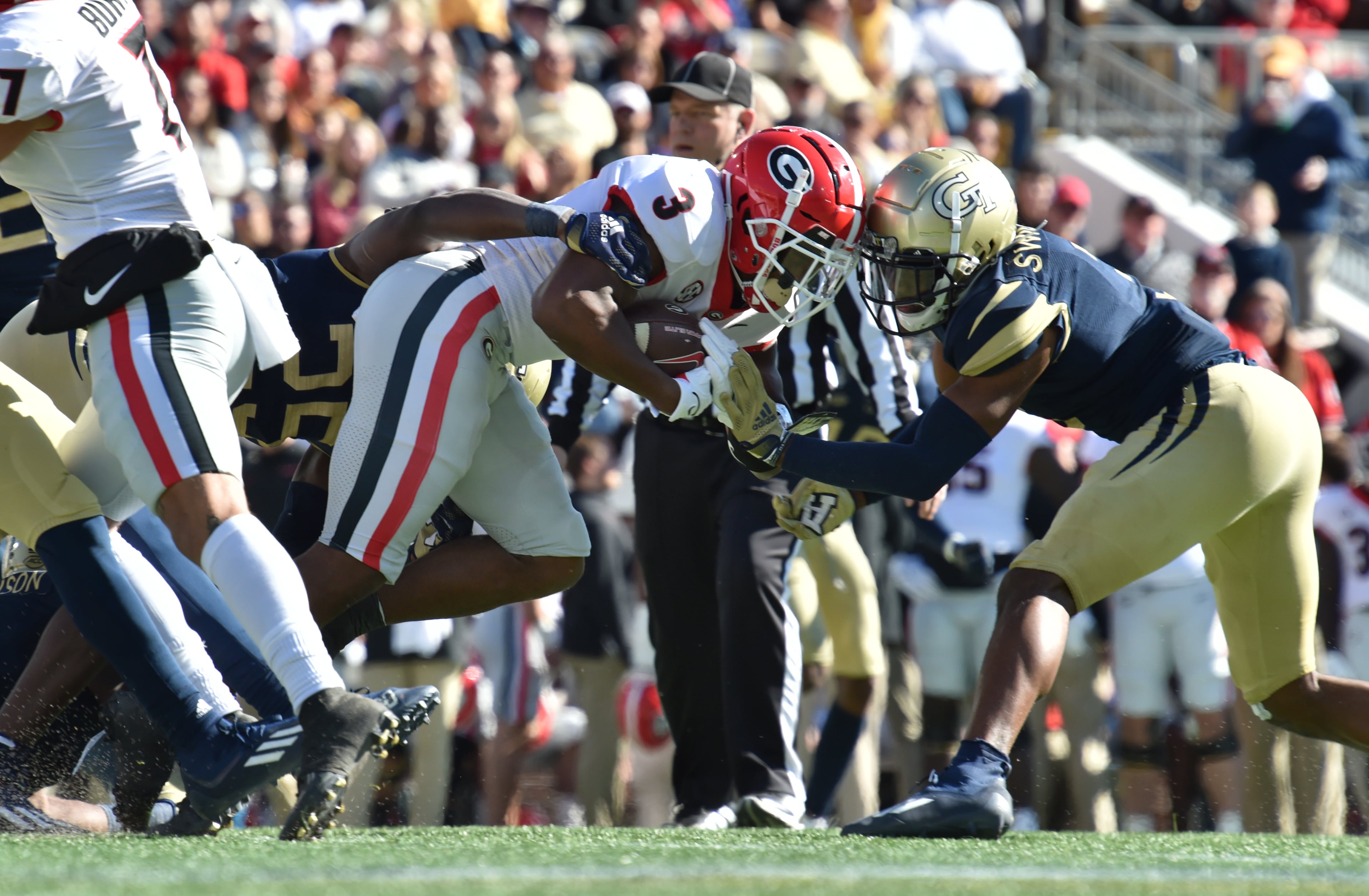 Georgia's running back Zamir White (3) rushes against Georgia Tech's defensive back Tre Swilling (3) during the first half of an NCAA college football game at Georgia Tech's Bobby Dodd Stadium in Atlanta on Saturday, November 27, 2021. Georgia won 45-0 over Georgia Tech. (Hyosub Shin / Hyosub.Shin@ajc.com)
