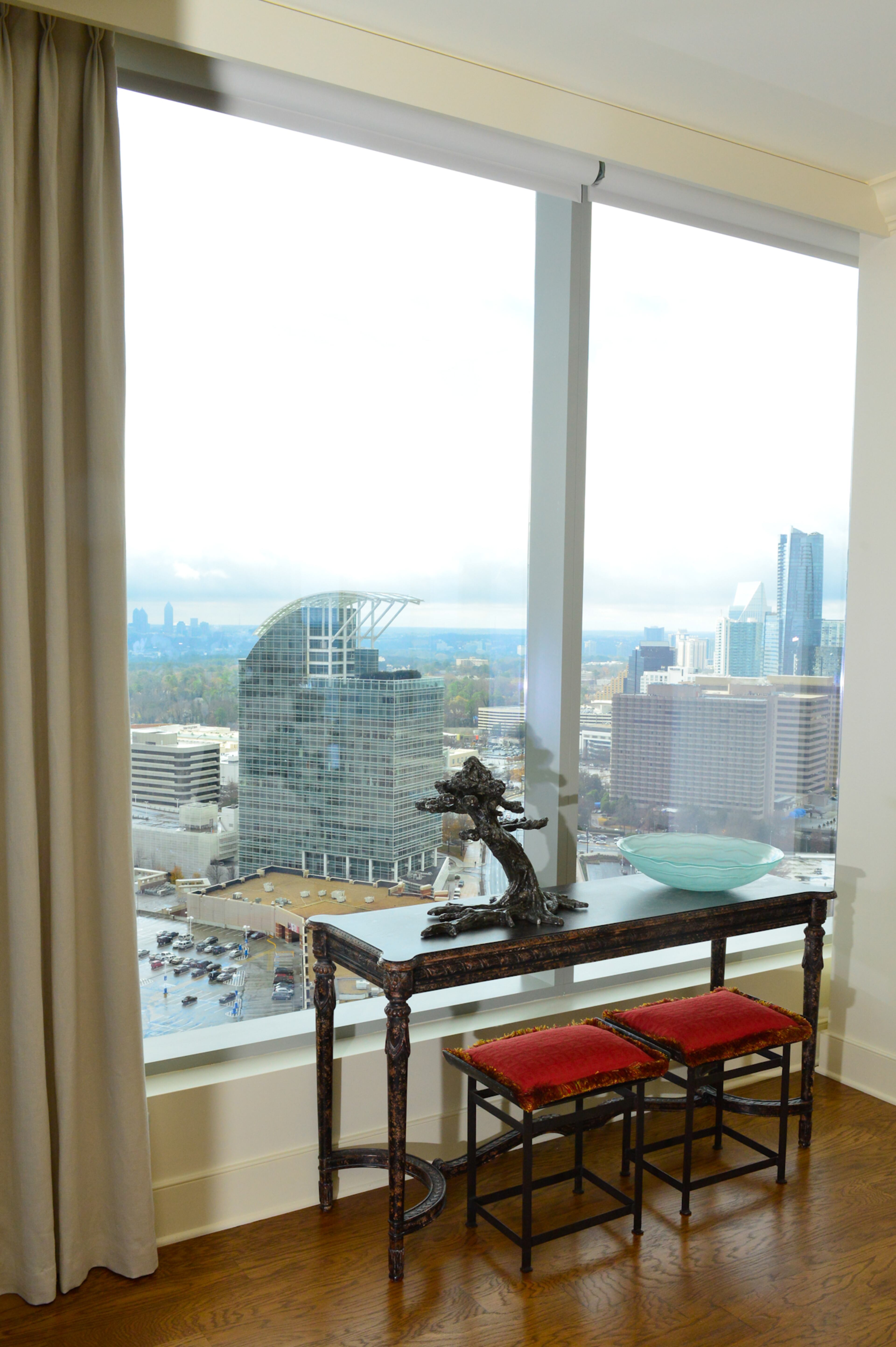 The interior selections for Mark and Sara Kanov's 2,700-square-foot condo in the Ritz-Carlton Residences, Atlanta don't block the expansive views of Midtown, downtown Atlanta, Stone Mountain, Kennesaw Mountain and neighboring buildings in Buckhead. The selected Antique White from Sherwin-Williams for the wall color.