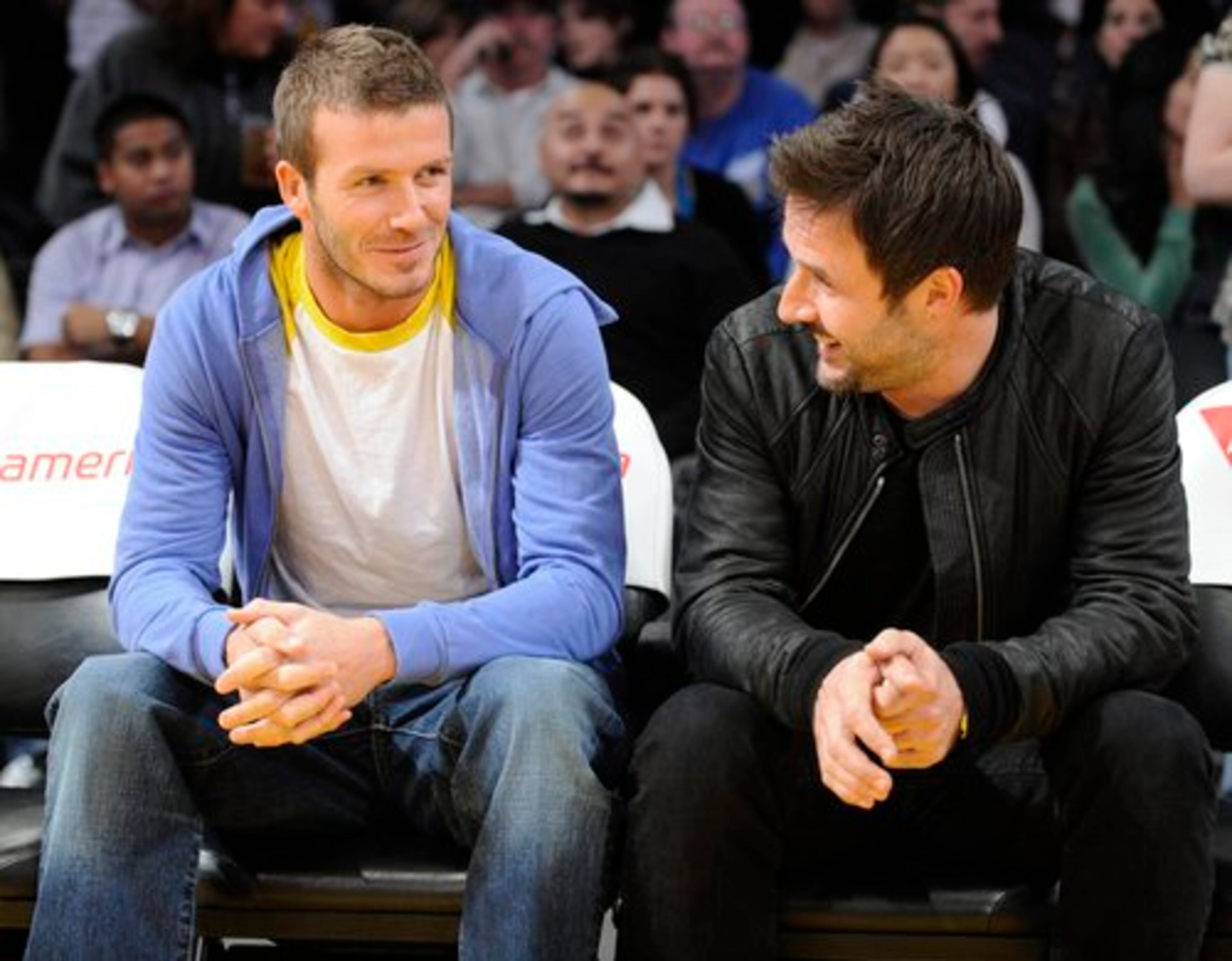 Los Angeles Galaxy soccer player David Beckham, left, and David Arquette distract themselves from the Los Angeles Lakers game vs. the New York Knicks on Dec. 16 in Los Angeles.