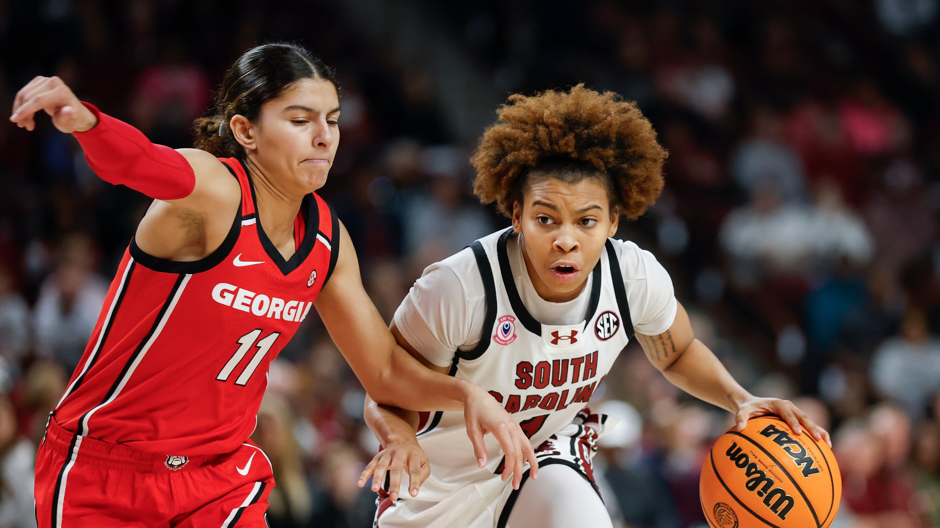 South Carolina guard Maddy McDaniel, right, moves the ball against Georgia guard Enjulina Gonzalez during the first half of an NCAA college basketball game in Columbia, S.C., Sunday, Jan. 11, 2026. (AP Photo/Nell Redmond)