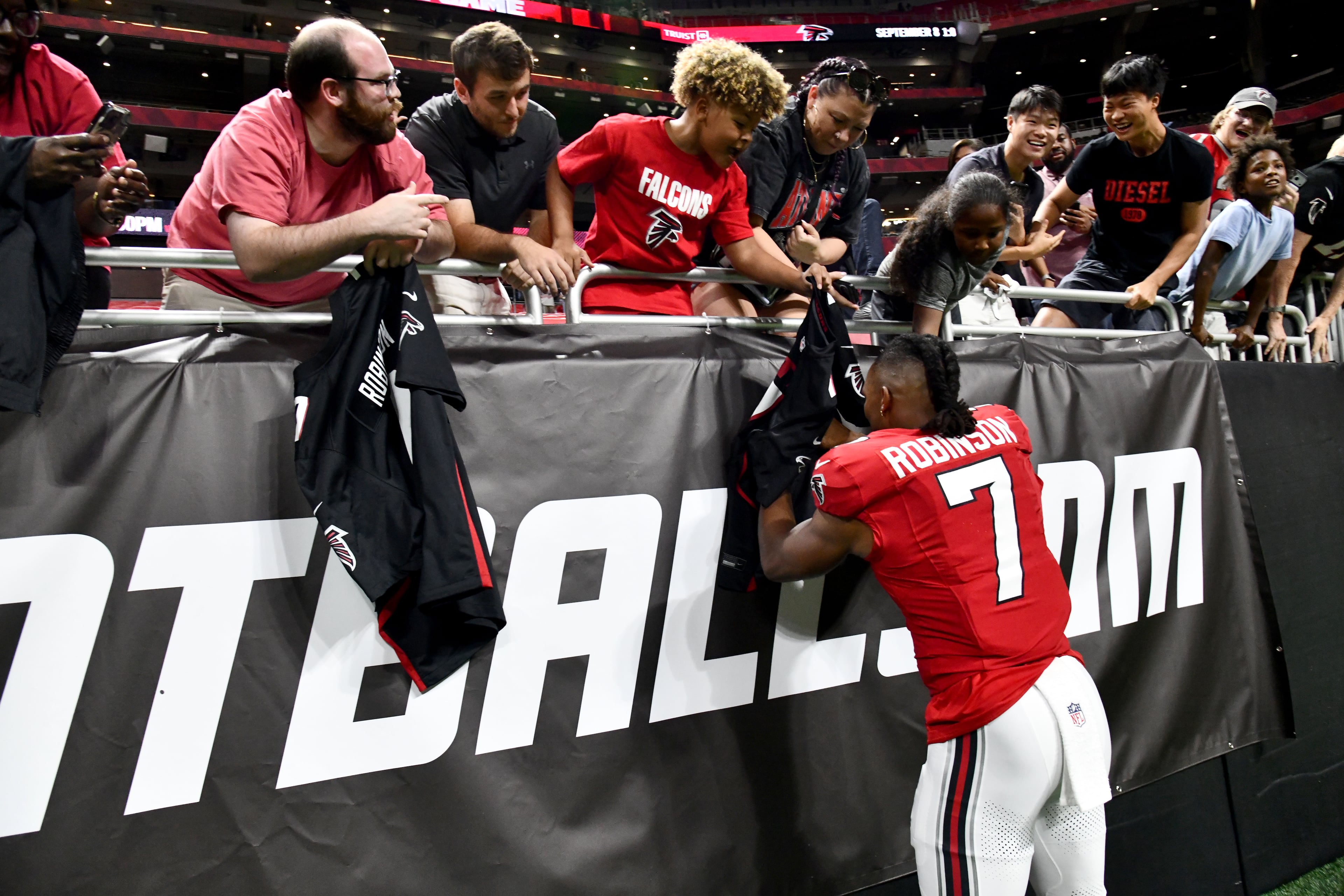 Falcons running back Bijan Robinson signs autographs for fans after the Denver Broncos defeated the Atlanta Falcons, 27-7, during their preseason game at Mercedes-Benz Stadium on Friday, Aug. 14, 2026, in Atlanta. (Hyosub Shin/AJC)