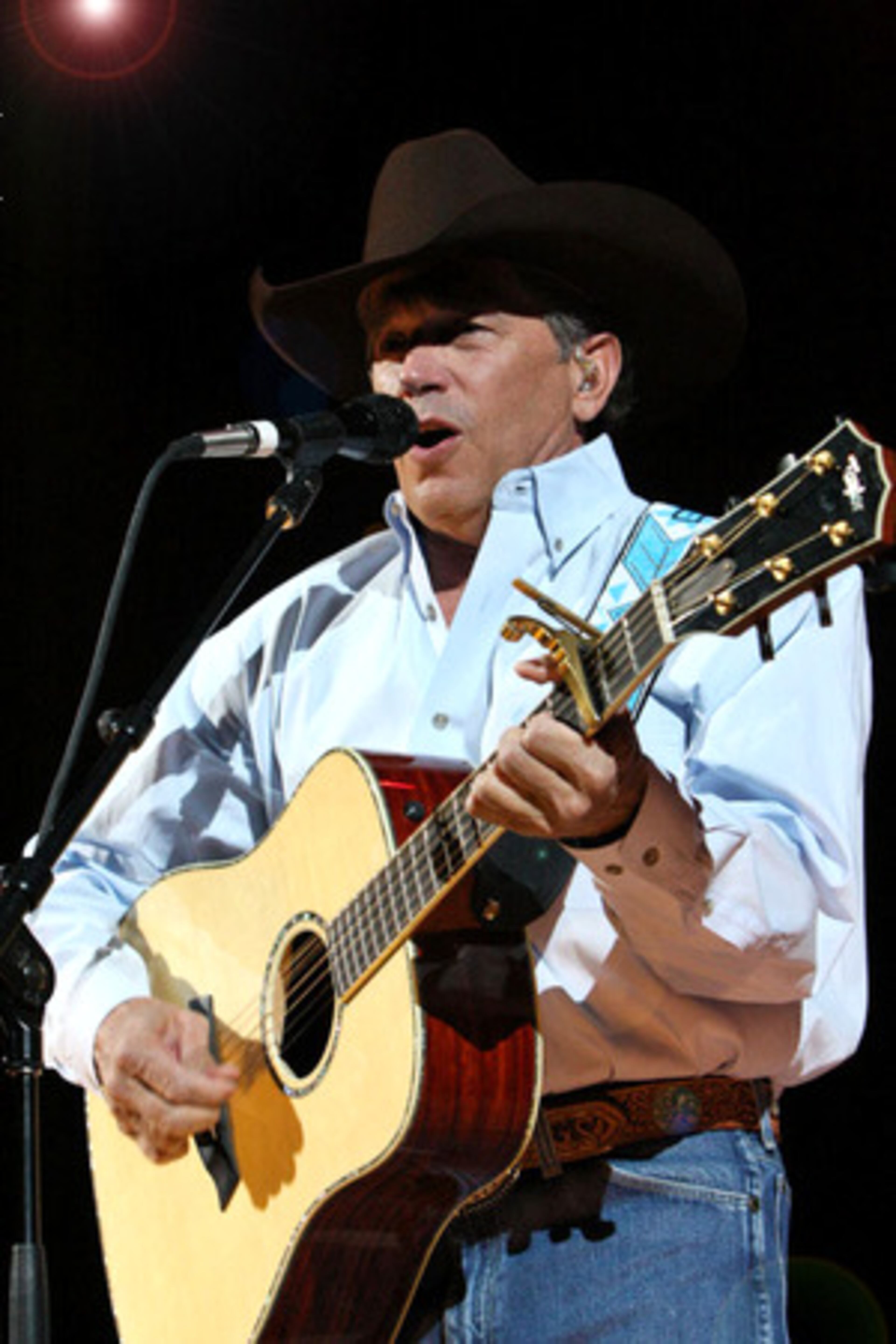 George Strait performs "Ocean Front Property" Friday night at sold out Gwinnett Arena. He holds the record for most No. 1 Billboard country hits with 42.