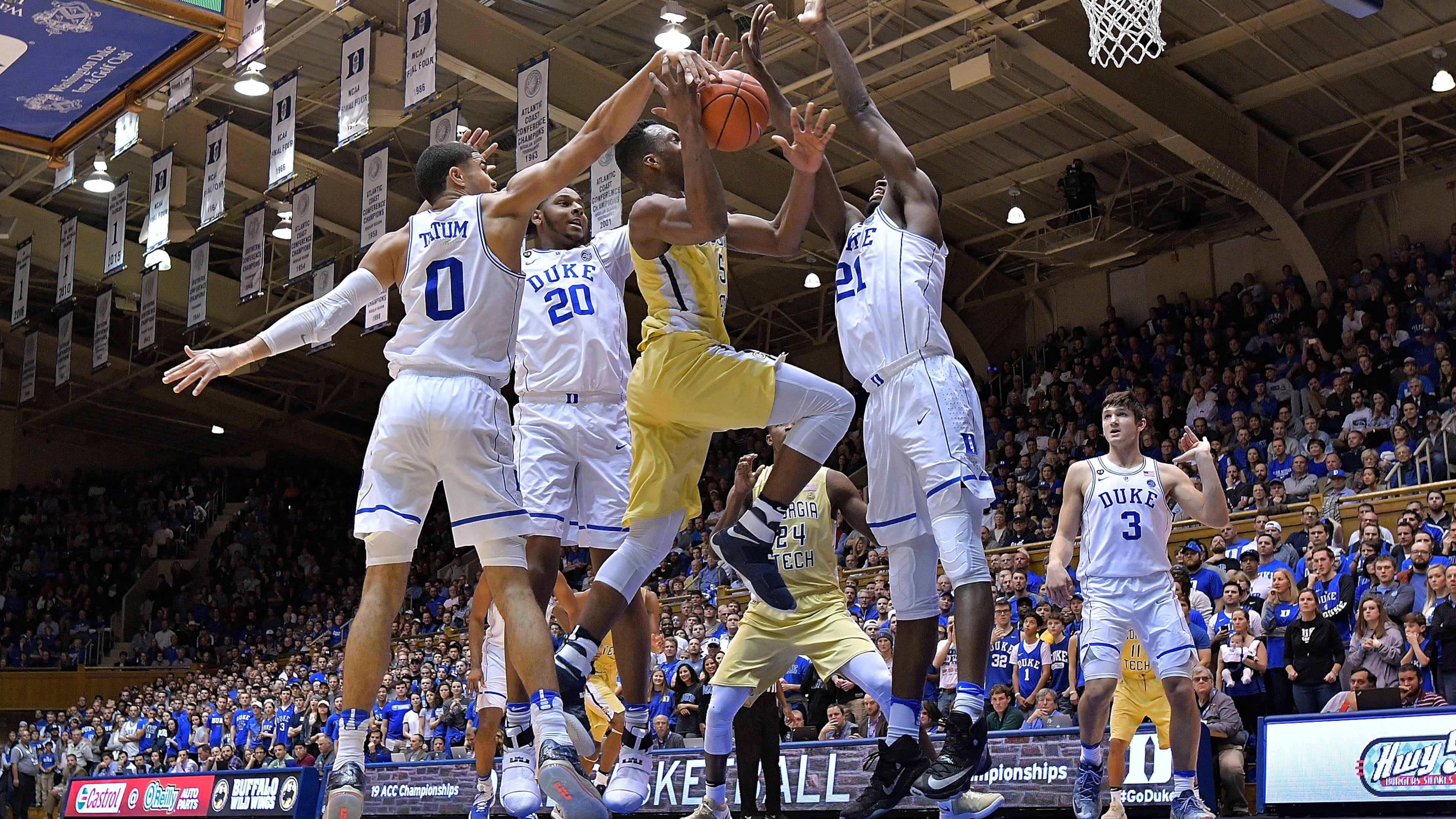 Josh Okogie of the Georgia Tech Yellow Jackets drives between Jayson Tatum (0), Marques Bolden (20) and Amile Jefferson (21) of the Duke Blue Devils during the game at Cameron Indoor Stadium on January 4, 2017 in Durham, North Carolina. Duke won 110-57. (Photo by Grant Halverson/Getty Images)