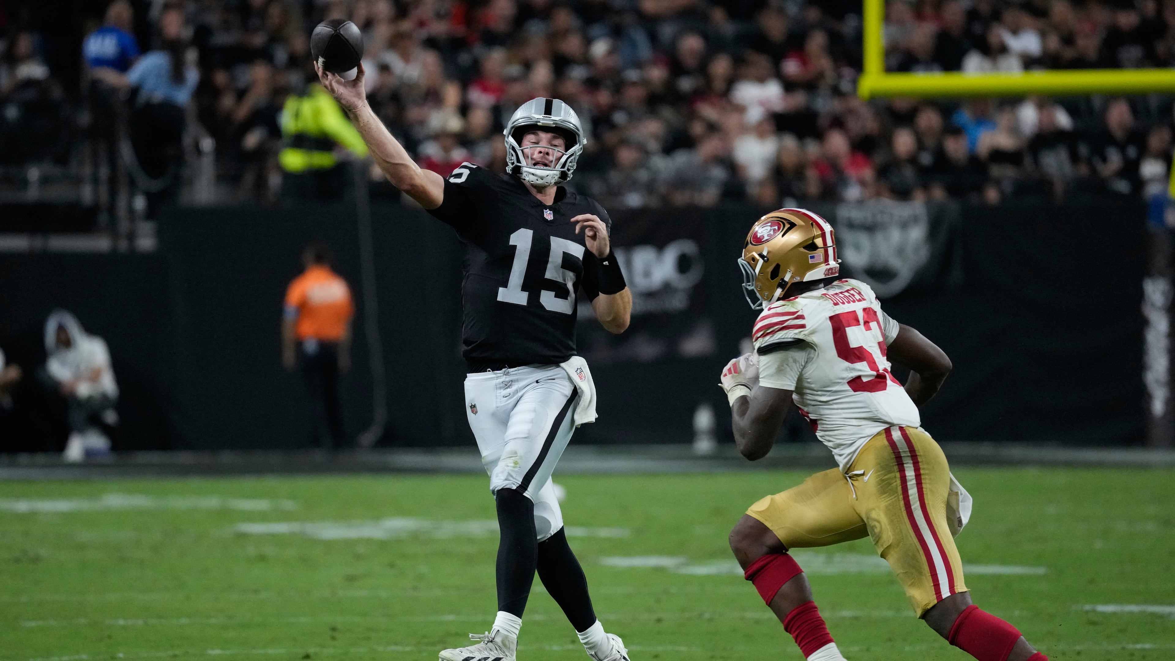 Las Vegas Raiders quarterback Fernando Mendoza (15) throws under pressure from San Francisco 49ers linebacker Jaden Dugger (53) during the second half of an NFL preseason football game, Thursday, Aug. 27, 2026, in Las Vegas. (AP Photo/John Locher)
